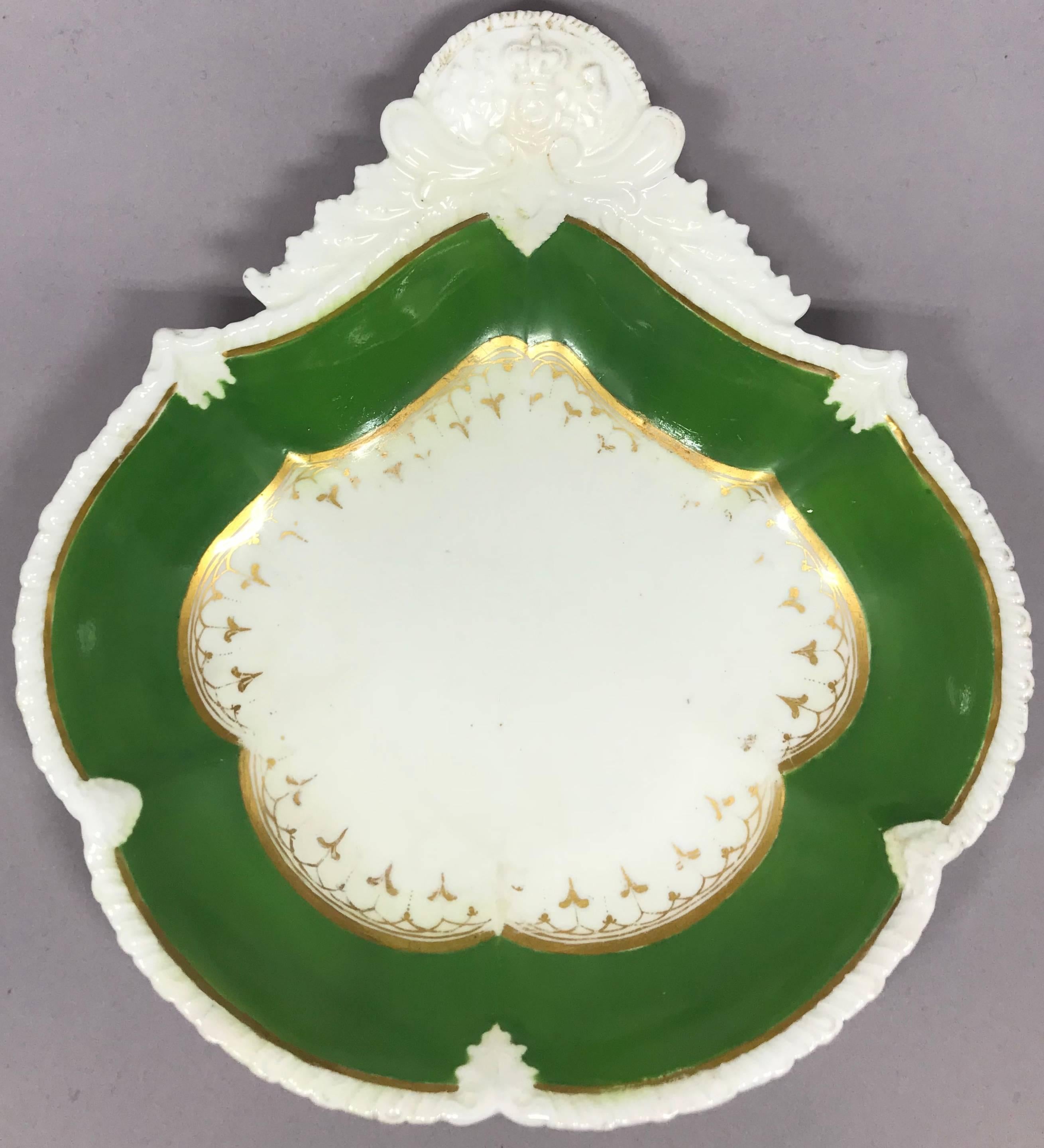 Set of English green and gilt banded serving dishes Scallop edged oval dish and shell form shaped sweetmeat dish with Scottish crowned thistle; both with gilt border. 
Dimensions: Oval plate 11.5