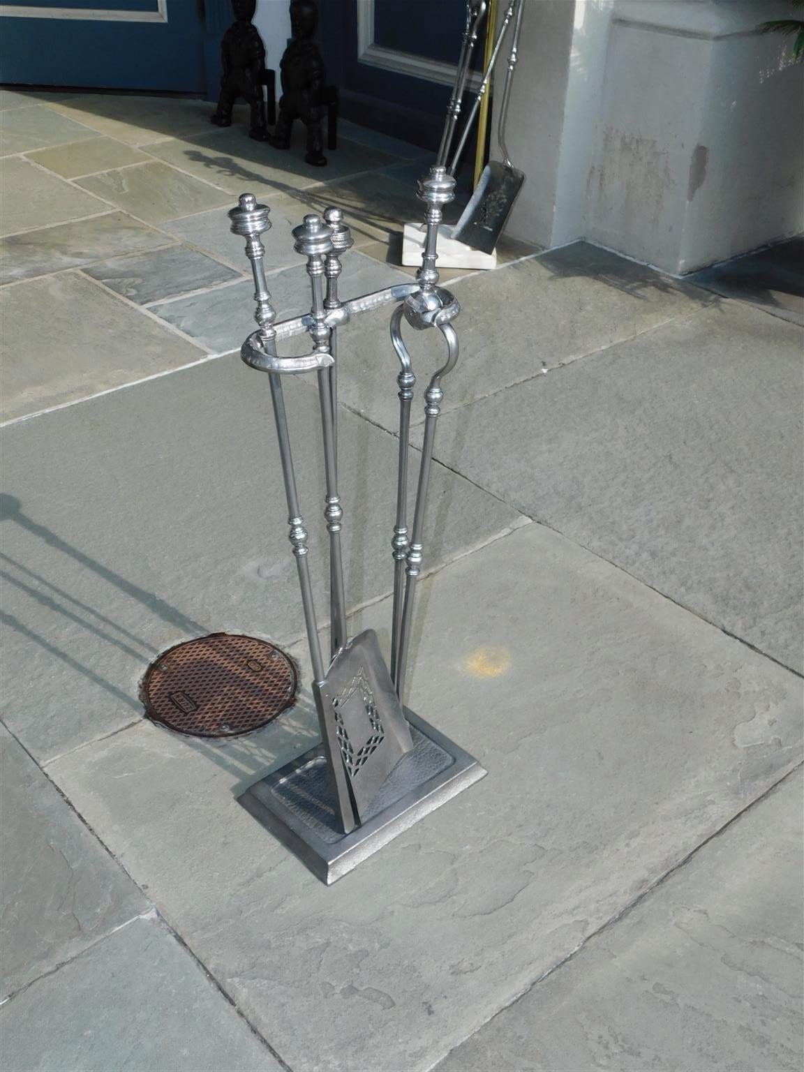 Set of English polished steel urn finial fire place tools on stand, Mid 19th century Set consist of tong, pierced shovel, and poker.