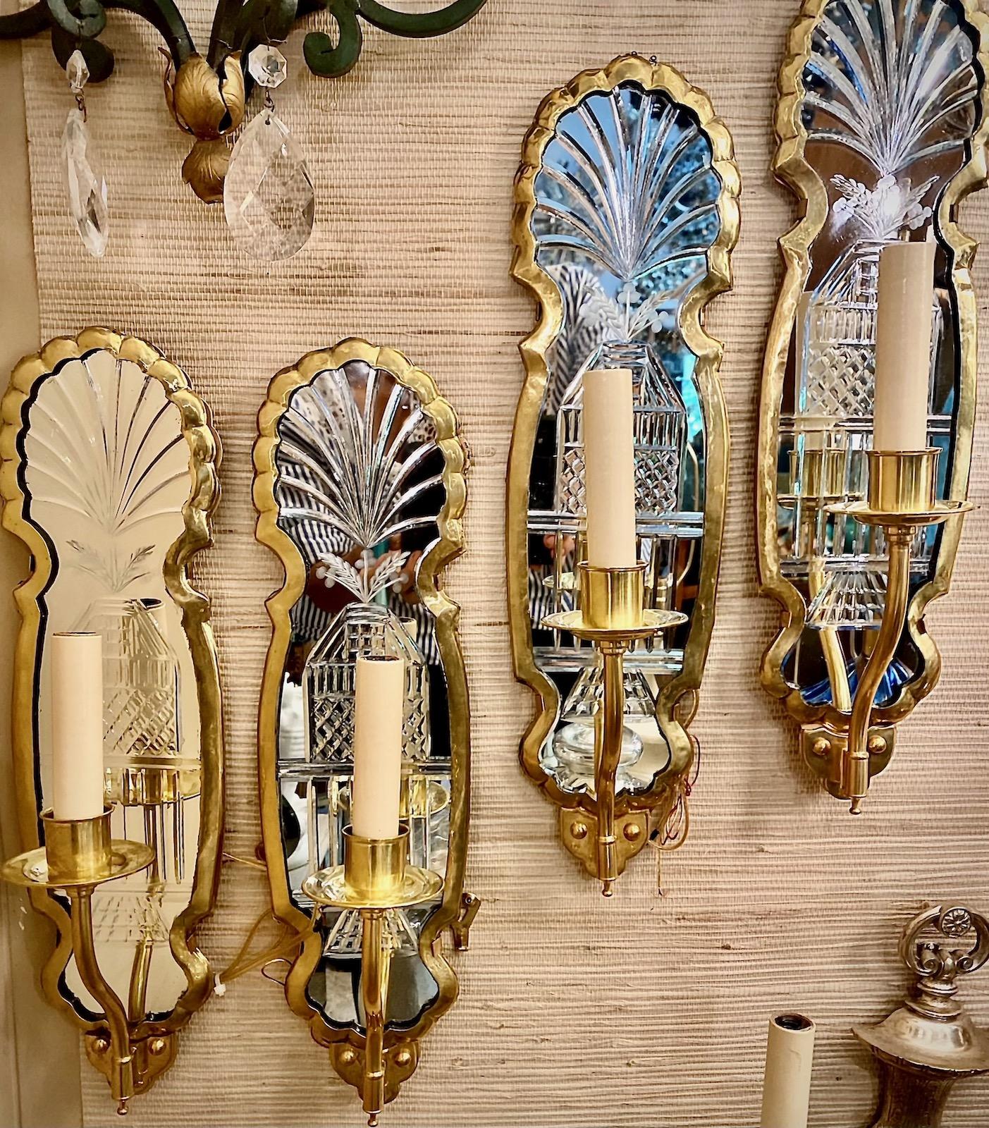 Un set di quattro applique francesi a luce singola a specchio acidato degli anni '50 circa, in metallo dorato. Venduto al paio.

Misure:
Altezza: 17