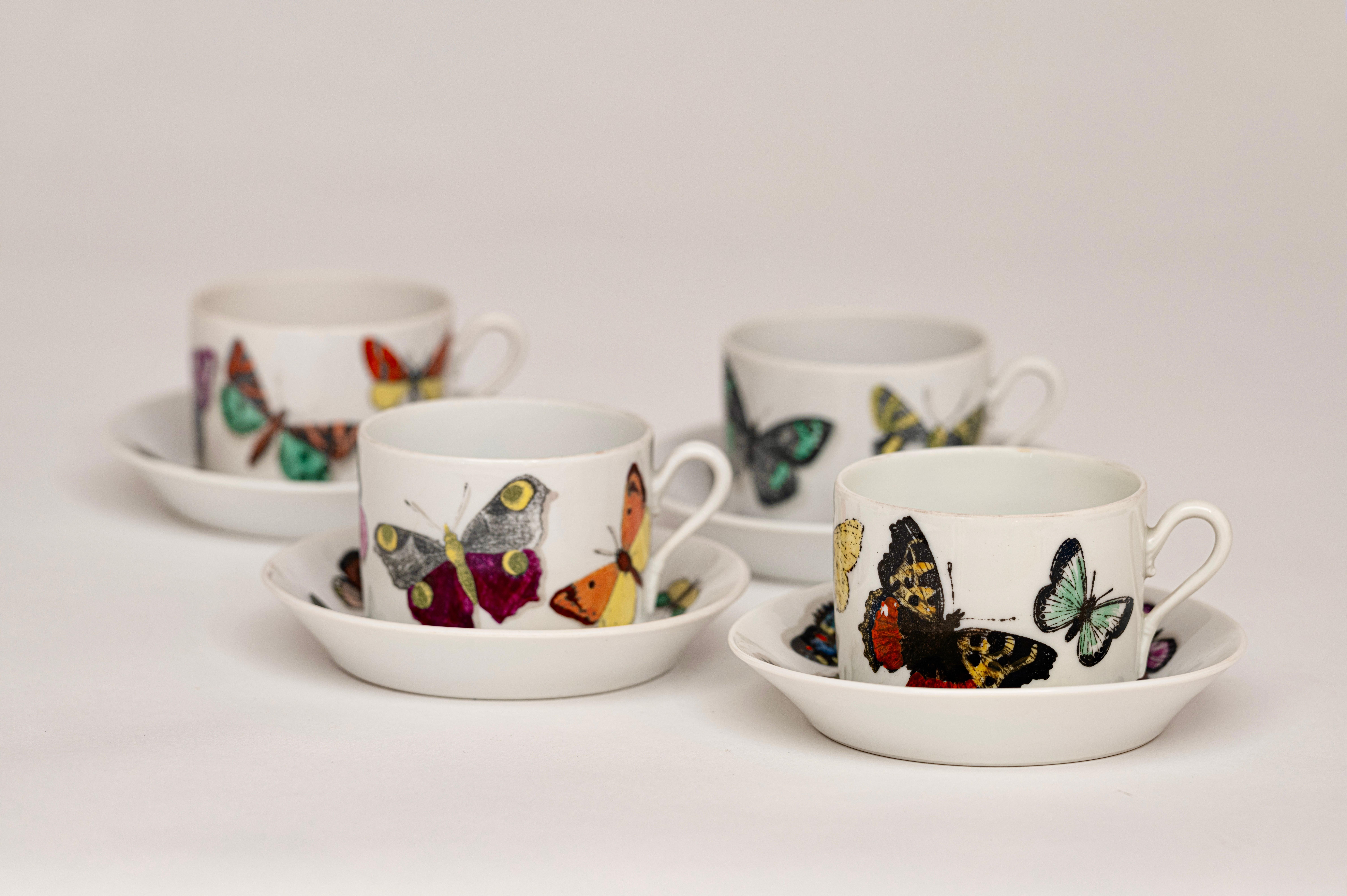 A rare and early set of 'Farfalle' (Butterflies) ceramic cups and saucers designed by Piero Fornasetti, circa 1955. Produced in collaboration with the historic Italian ceramics company, Richard Ginori, these wonderfully colourful vintage pieces have