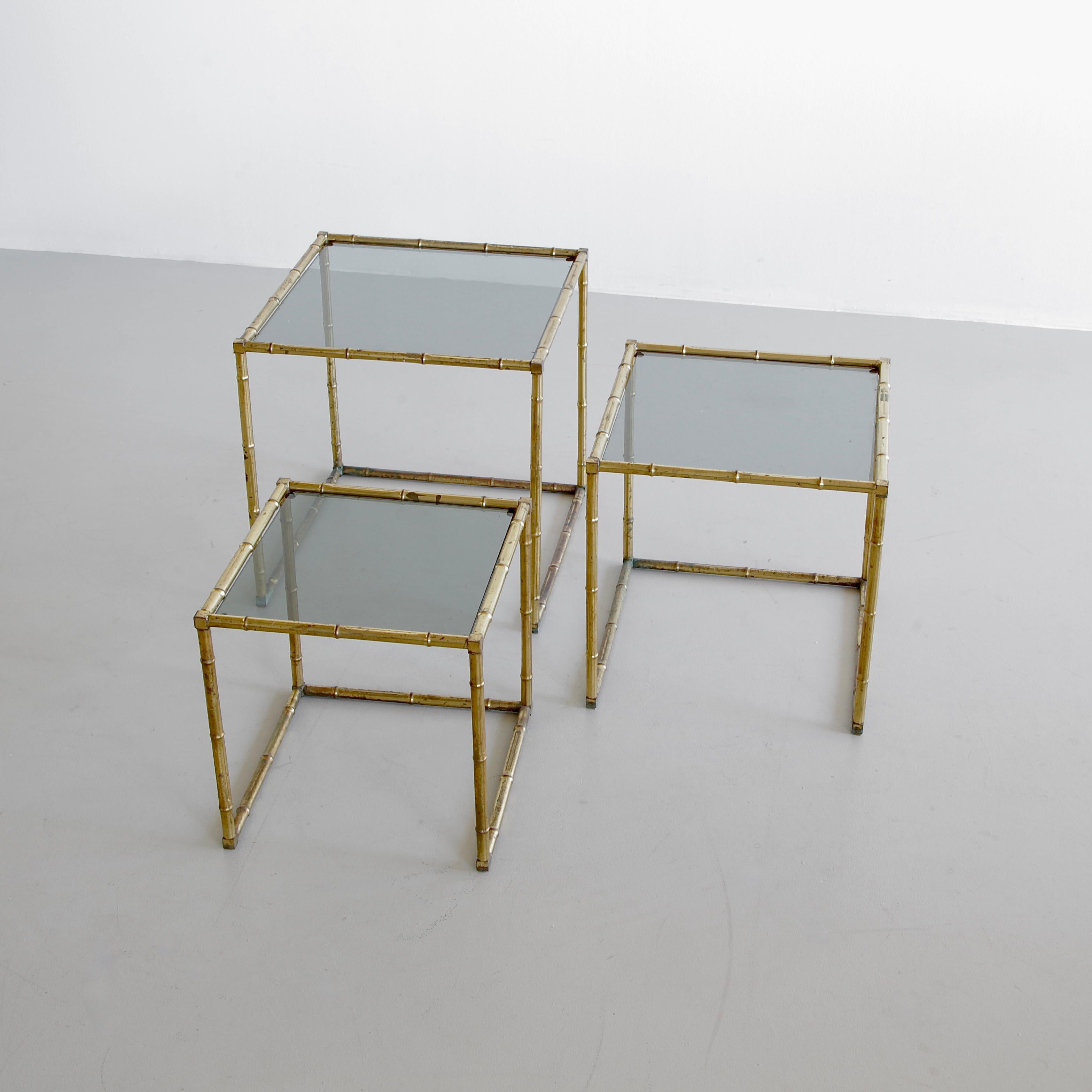 Set of three side nesting tables. France, 1960s.

Faux bamboo frames with lightly green-tinted glass tops. The size indicated is for the largest of the set. Please enquire about the other measurements.

  