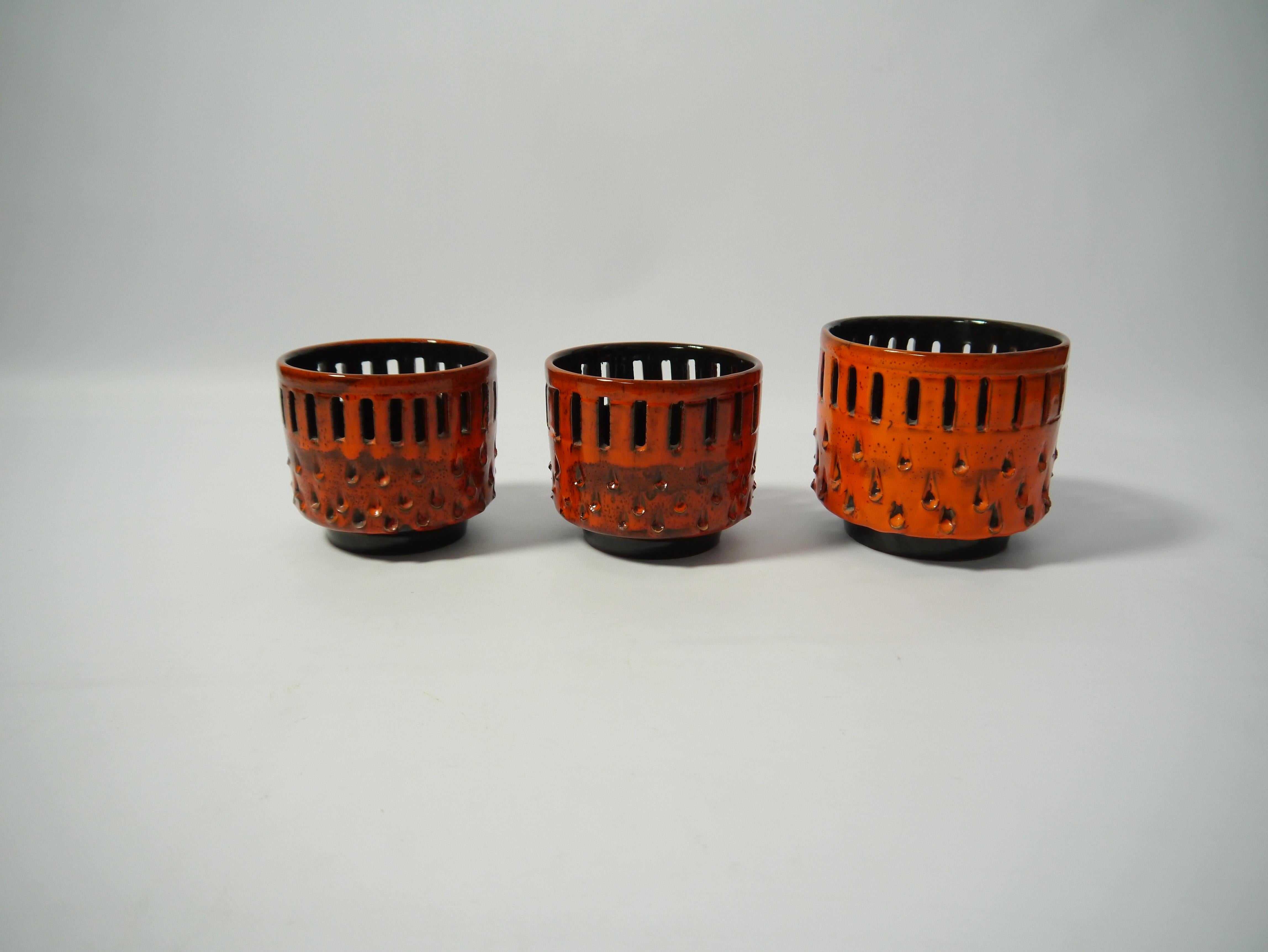 Set of three fiery orange ceramic flower pots / cachepots, 