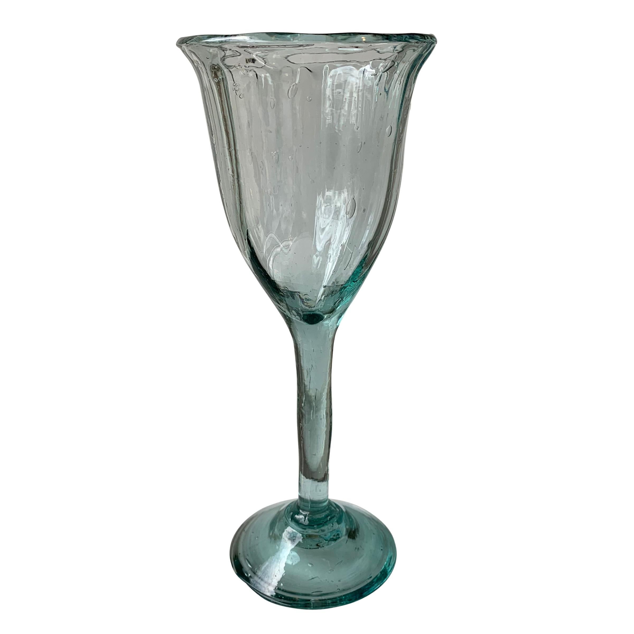 A wonderful set of fifteen Mexican hand blown wine glasses with captured bubbles and a slight swirled pattern. Each piece is unique and therefore different in size, shape, etc...