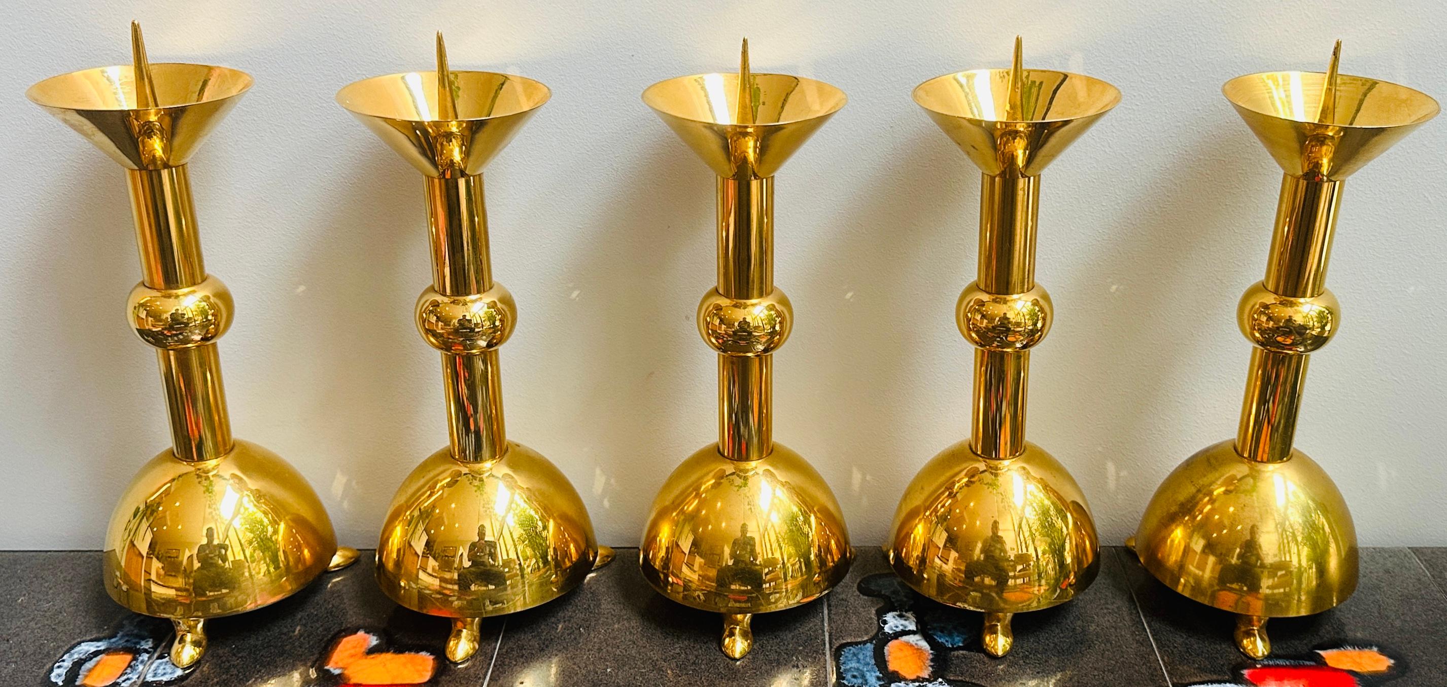 Set of five 1950s German candle holders featuring gold-chrome metalwork with a distinctive Brutalist aesthetic. Each piece showcases the movement's characteristic geometric composition—round bulbous base, cylindrical stem with spherical accent, and