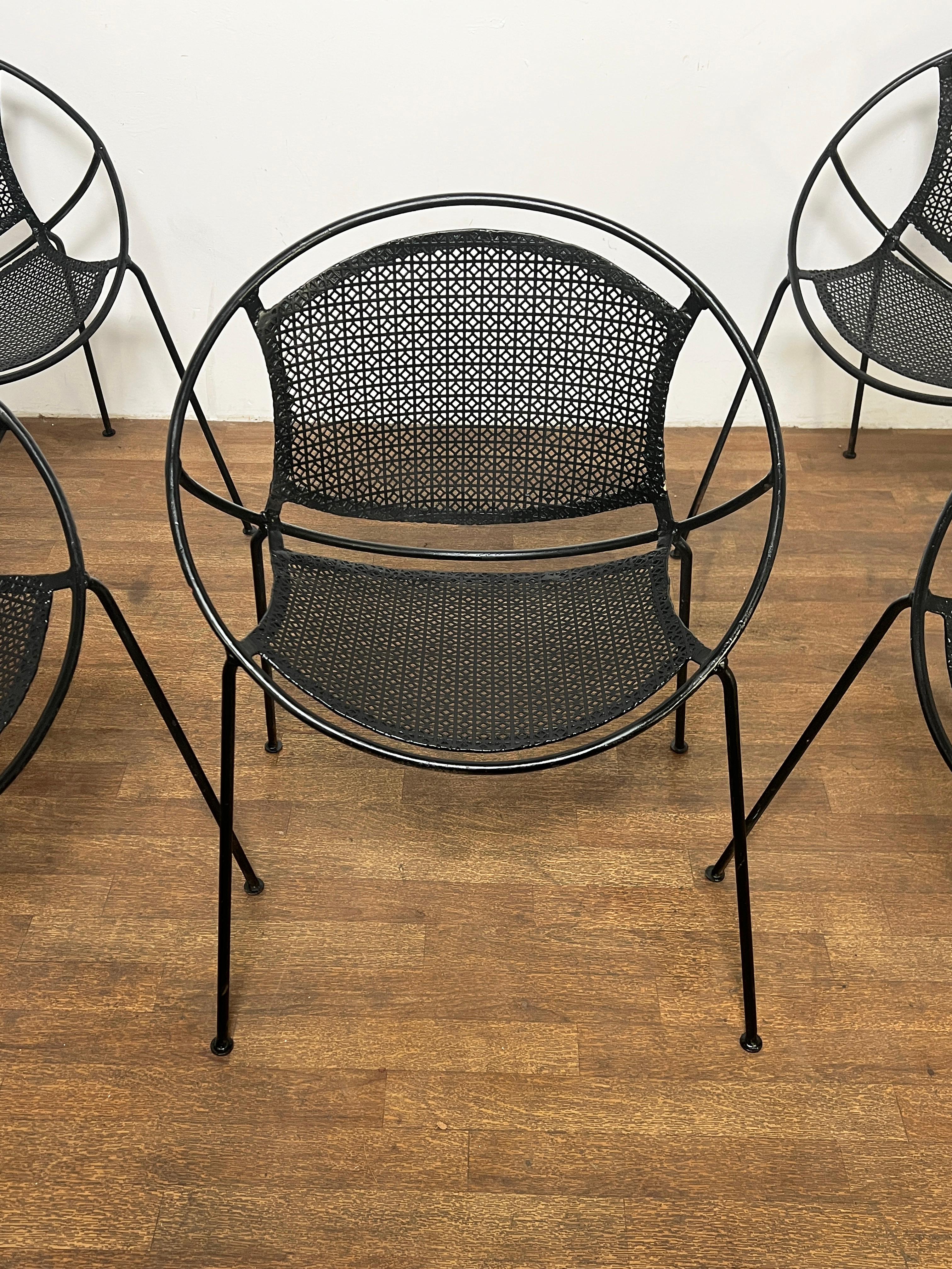 Set of five outdoor hoop chairs, ca. 1950s, in the manner of Maurizio Tempestini’s “Radar” chair for Salterini. The basket weave pattern of their pierced metal seats and backs is almost more evocative of the period than the open screening of the