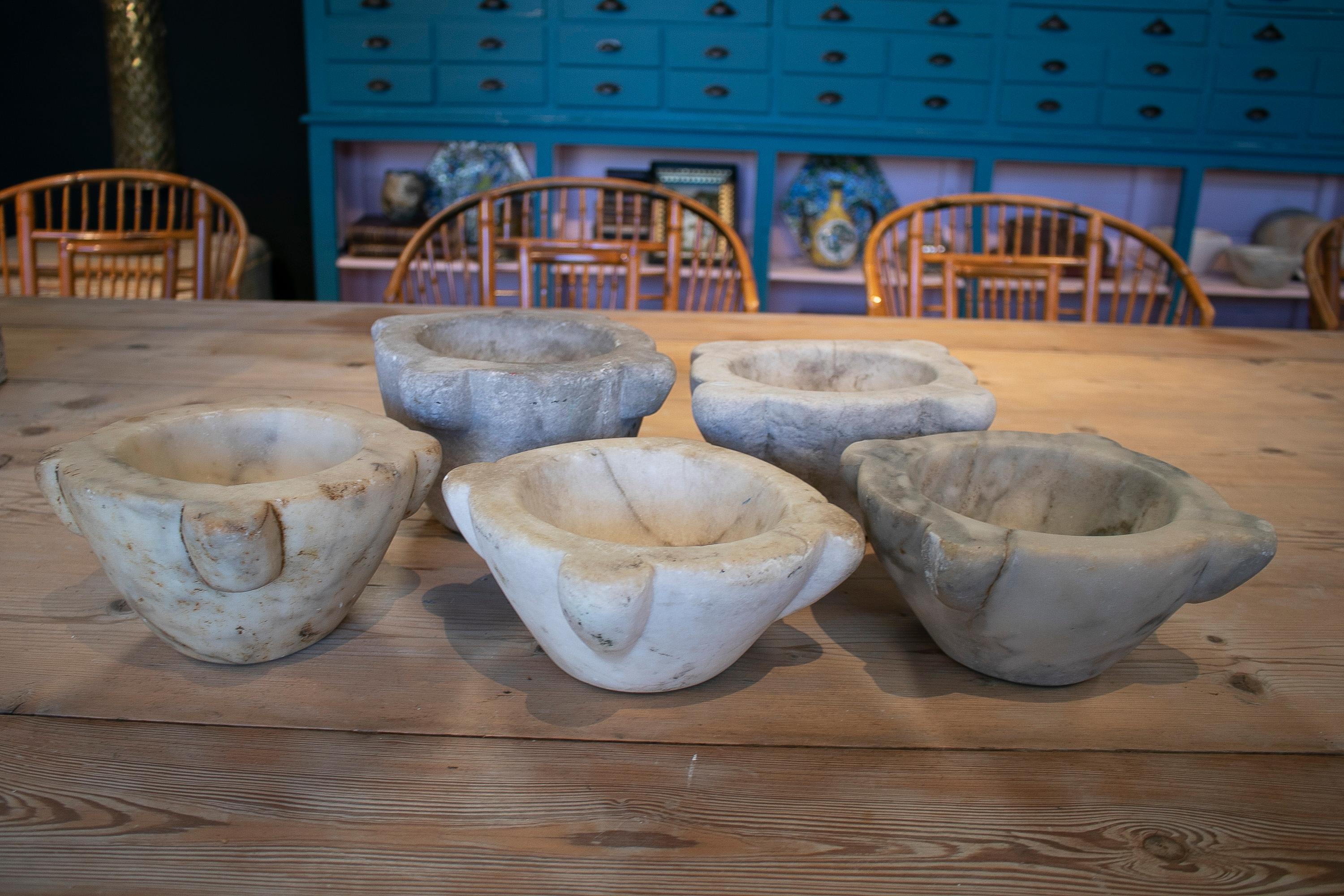 Set of five 1950s rustic Spanish hand carved marble kitchen mortars in different sizes.