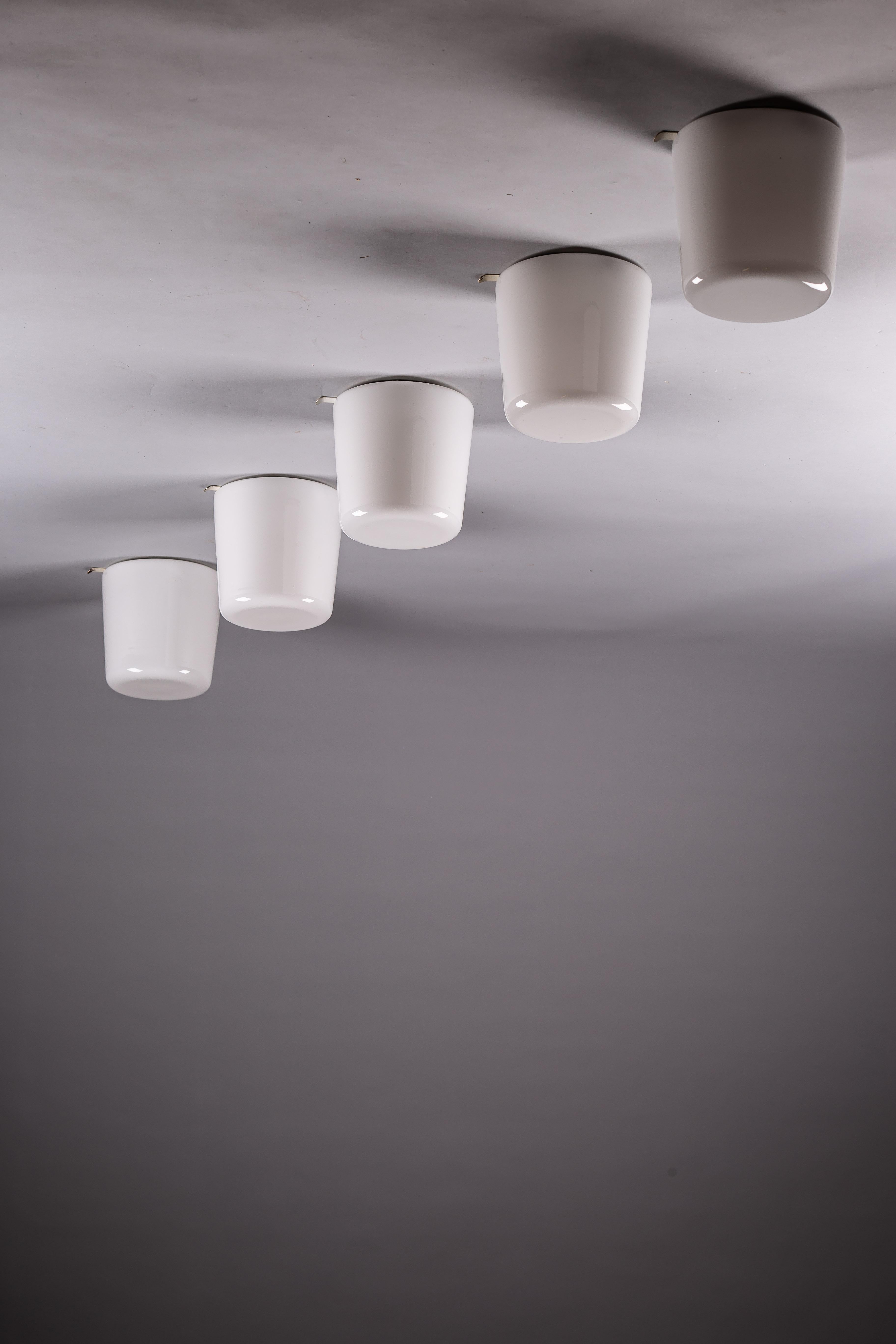 Illuminate your home with a touch of vintage Scandinavian charm through this set of five 1960's opaline glass flush mounts from Itsu, Finland. Crafted with elegance and an eye for timeless design, these flush mounts are perfect for any space seeking