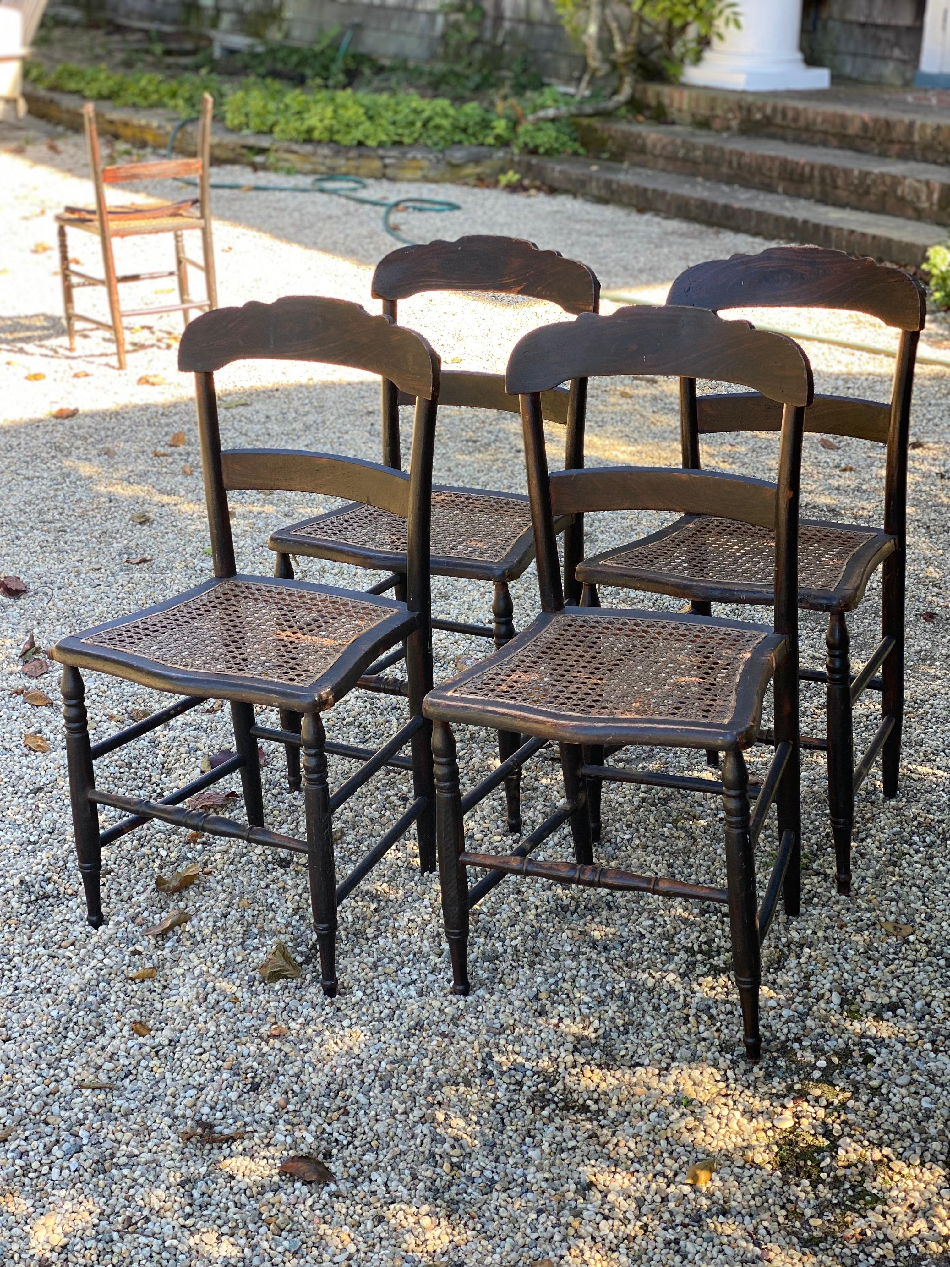 Set of Five 19th Century American Caned Faux Bois Rosewood Dining Chairs
In Rosewood Faux Bois Paint, hand caned seats, turned legs. Four chairs in good condition with general wear to the finish, particularly at edges. One chair with top rail