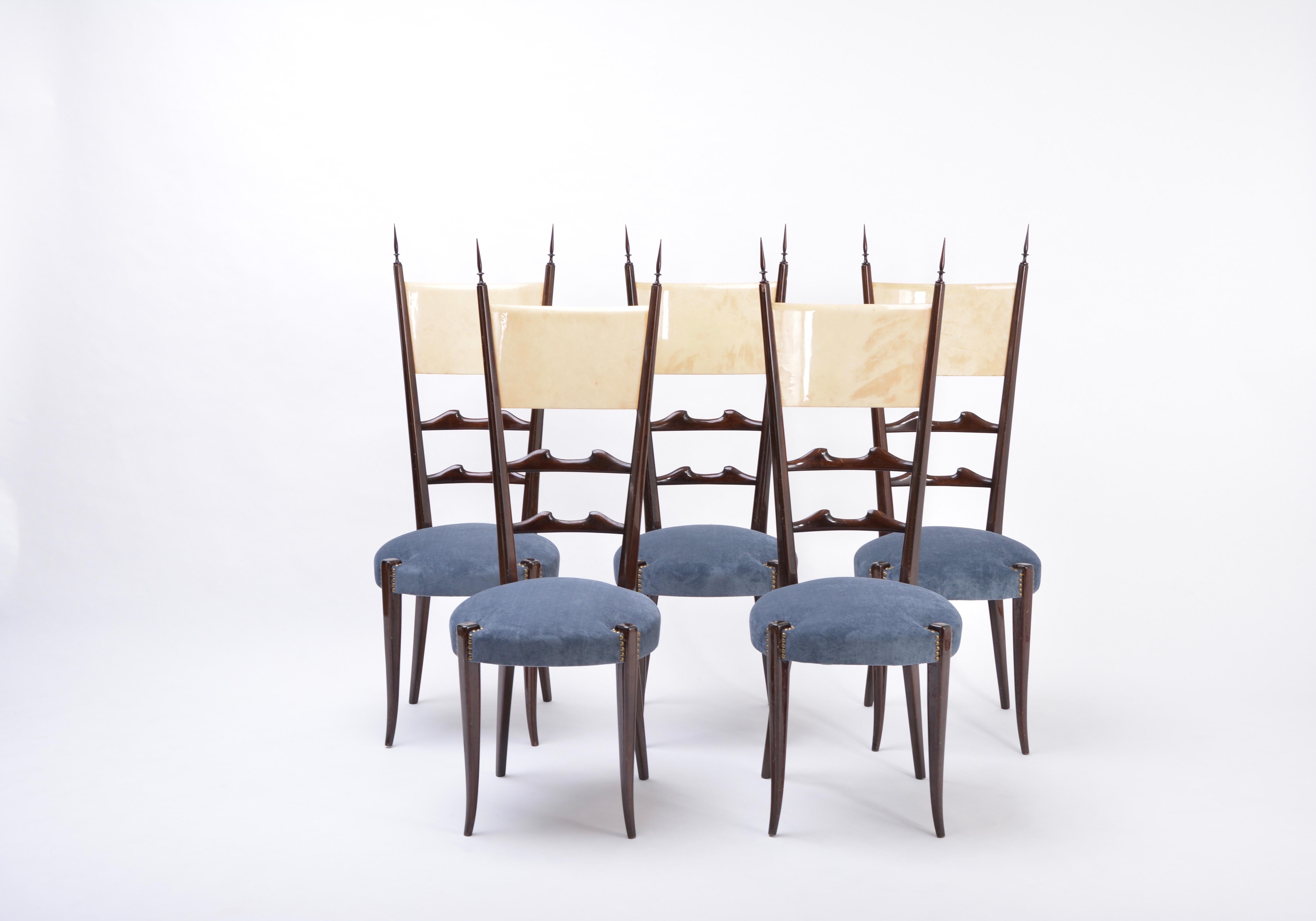 A set of five tall ladder-back dining chairs by Aldo Tura, circa 1950's. The chairs frames are made of gloss black ebonized wood and the backrests feature lacquered goatskin parchment applied on both front and back.
Born in 1909, Italian