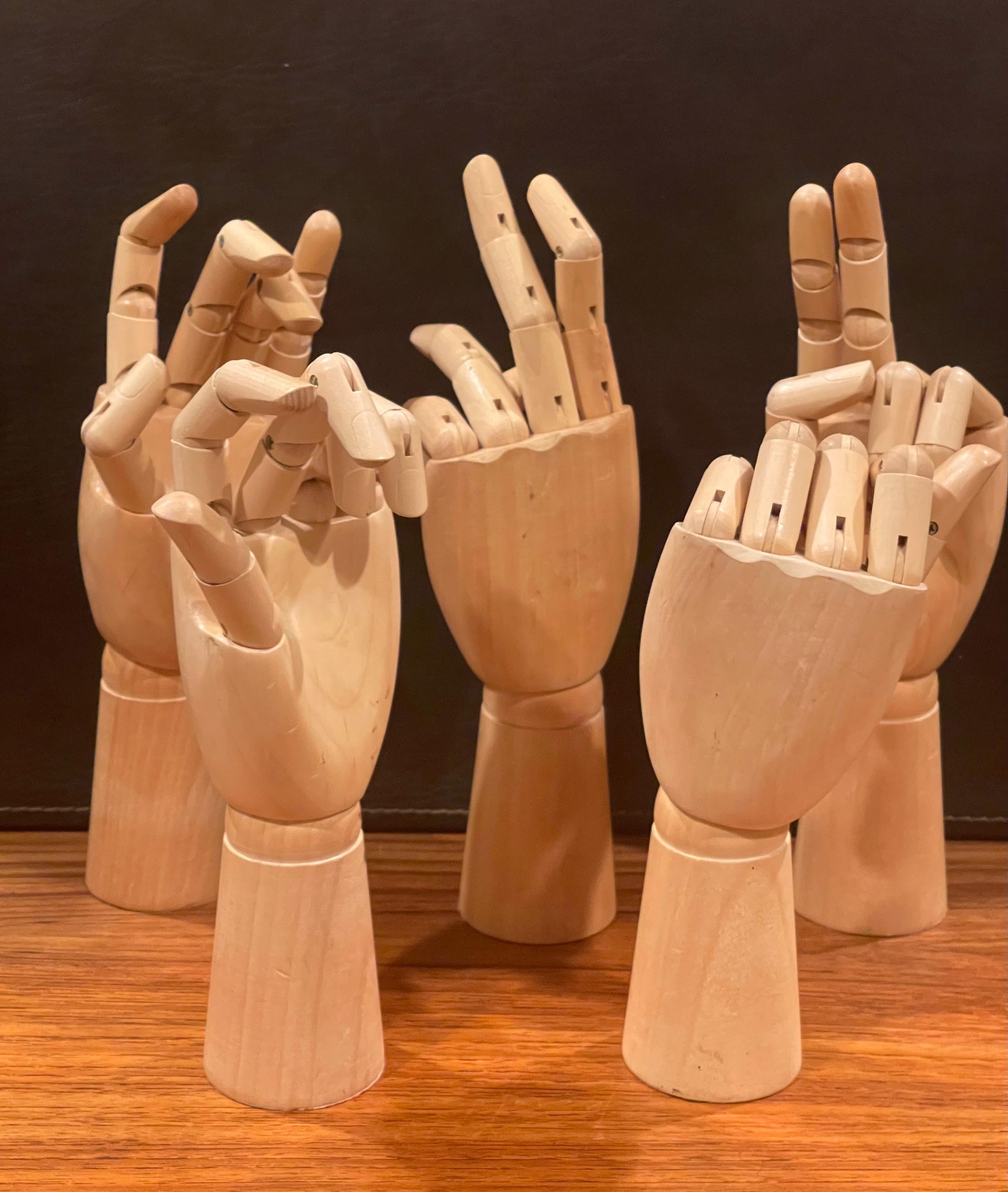 Unique set of five articulating hands, circa 1990s. The hands are extremely well made out of solid maple and have a number of articulating joints that allow the hands to be placed in an infinite amount of positions. They are in great condition and