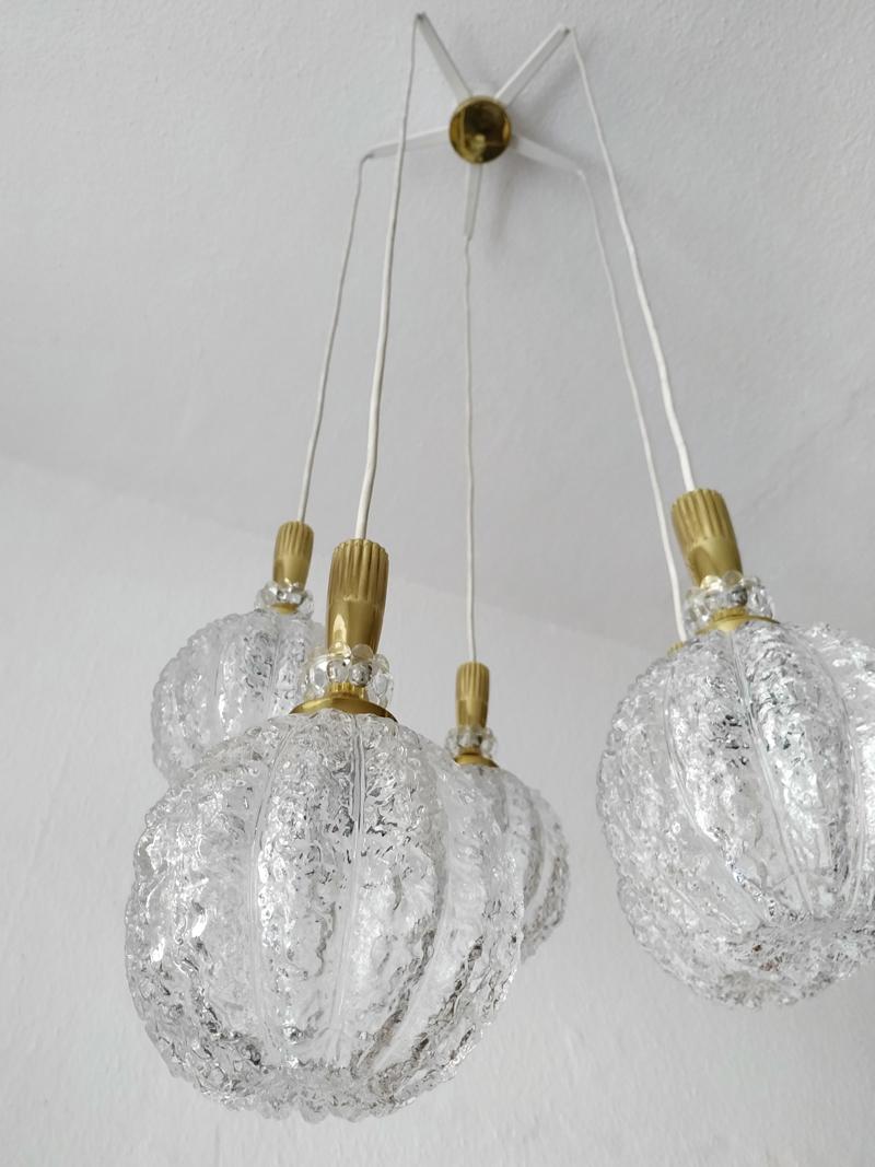Wonderful set of five textured ice glass globes and brass pendant lights with star canopy (on request also separately).
Austria, 1960s.
Glass globes: D: 6 in.

 
