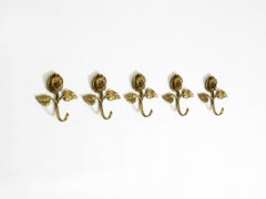 Set of five beautiful, solid mid-century brass rose wall coat hooks