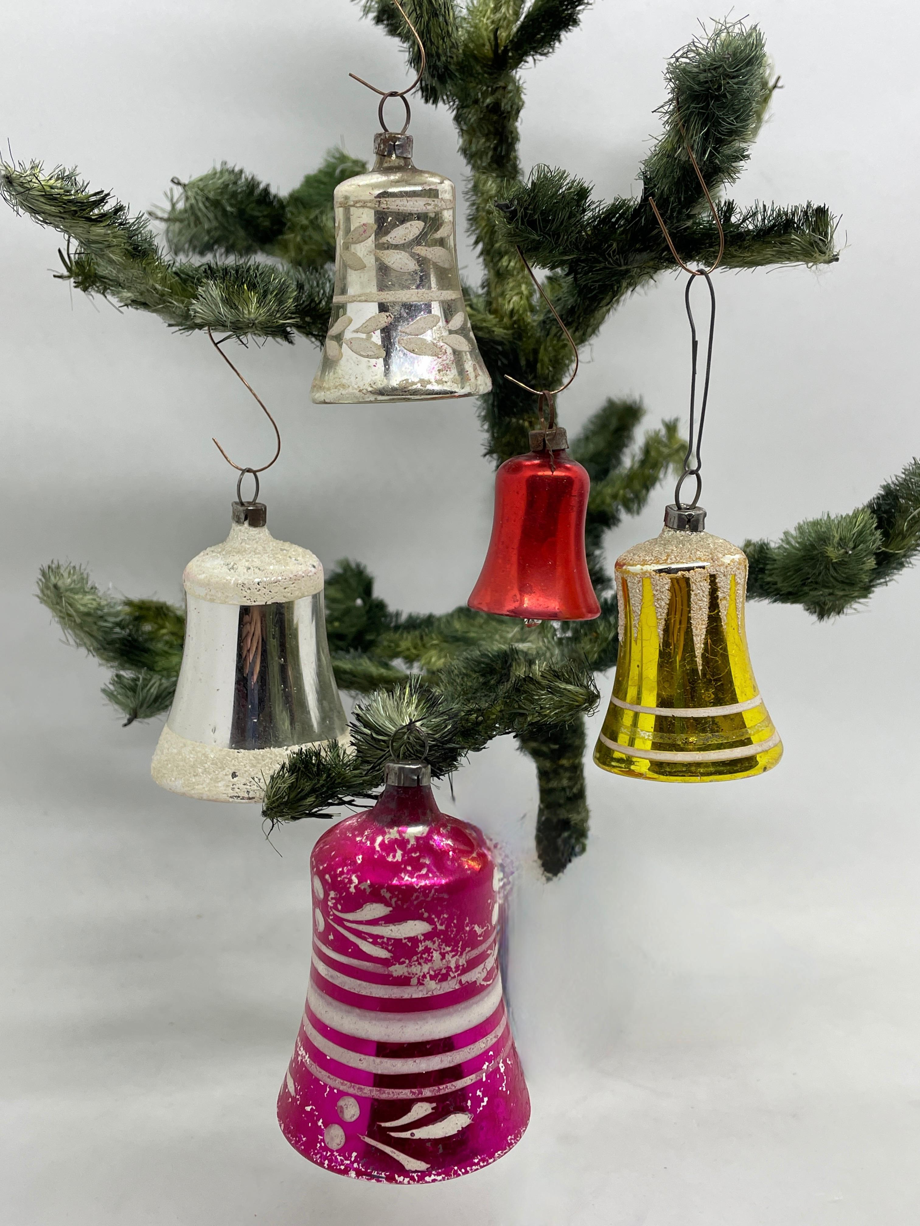 A rare Christmas ornament set off five bell glass ornaments. Each is made from thin mouth blown glass, this would be a great antique addition for your Christmas or feather tree. Measurements given for tallest bell.