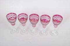 Set of five Bohemian pink crystal wine glasses with cut decoration. 1940s