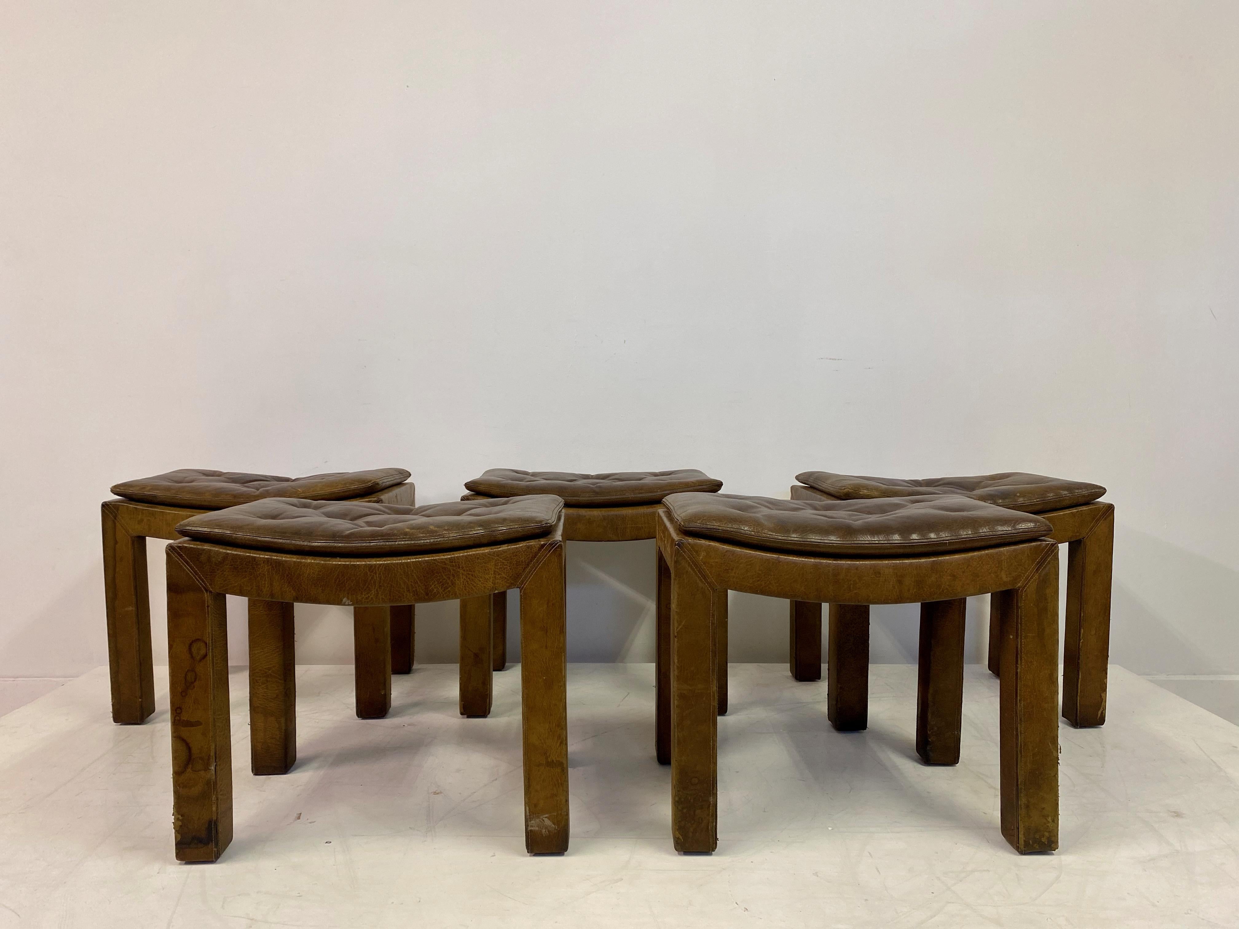 Set of five stools.

Buttoned leather seats.

Leather clad legs.

Mid to late 20th century.