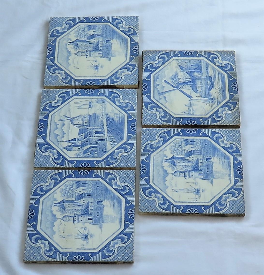 These are a good set of five glazed ceramic Delft style wall tiles, all with a blue and white waterside theme, manufactured in Belgium and dating to the early 20th century, circa 1920s. 

Each tile is nominally 6 inches square. The tiles are in