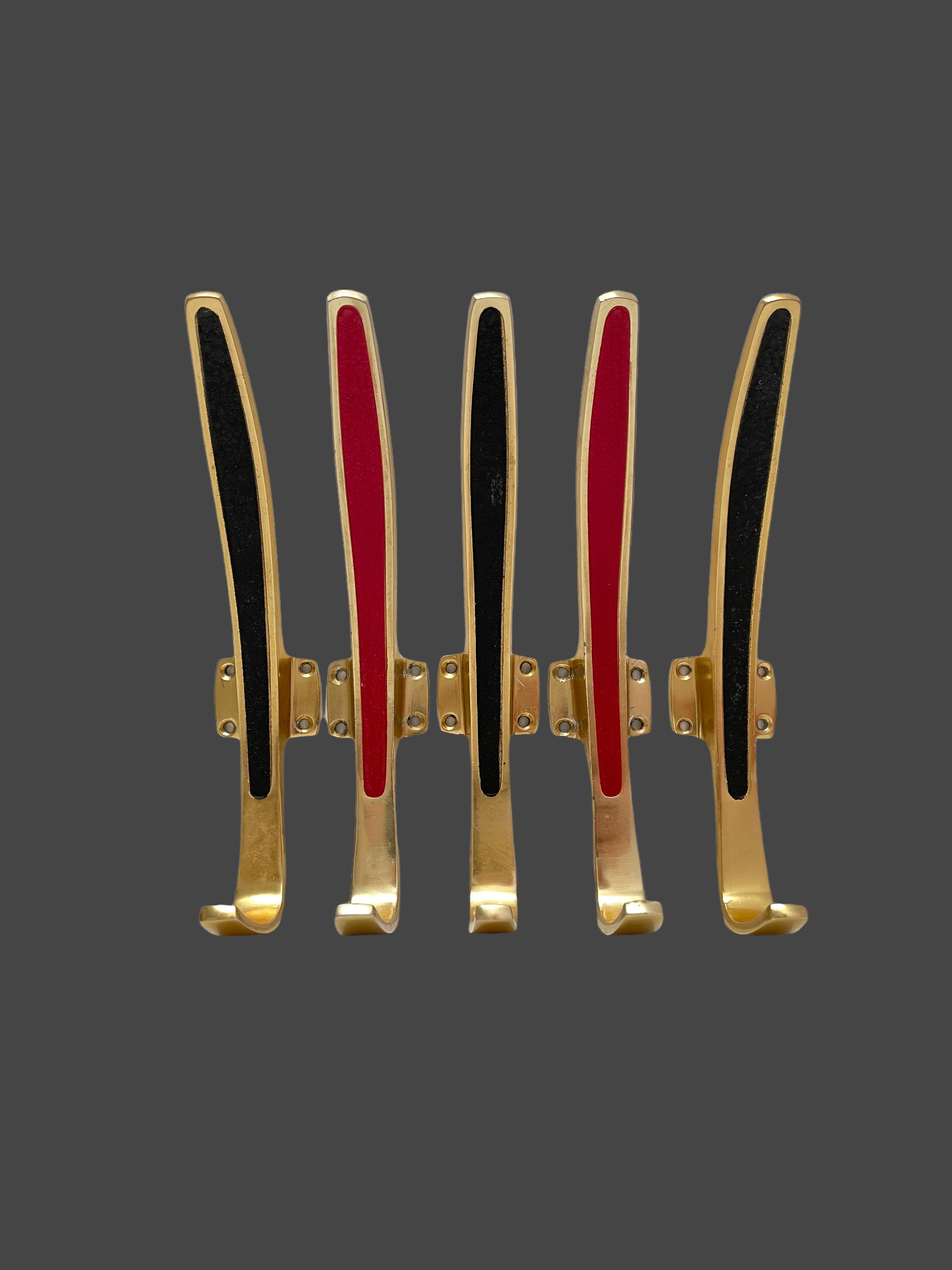 A set of five Bosse Baller Era style wall hooks, made in the 1950s. They are made of Brass with partly black or red lacquered paint. Wear of use, lovely patina, some use-lanes but this is old-age. Found at an Estate Sale in Nuremberg, Germany. A