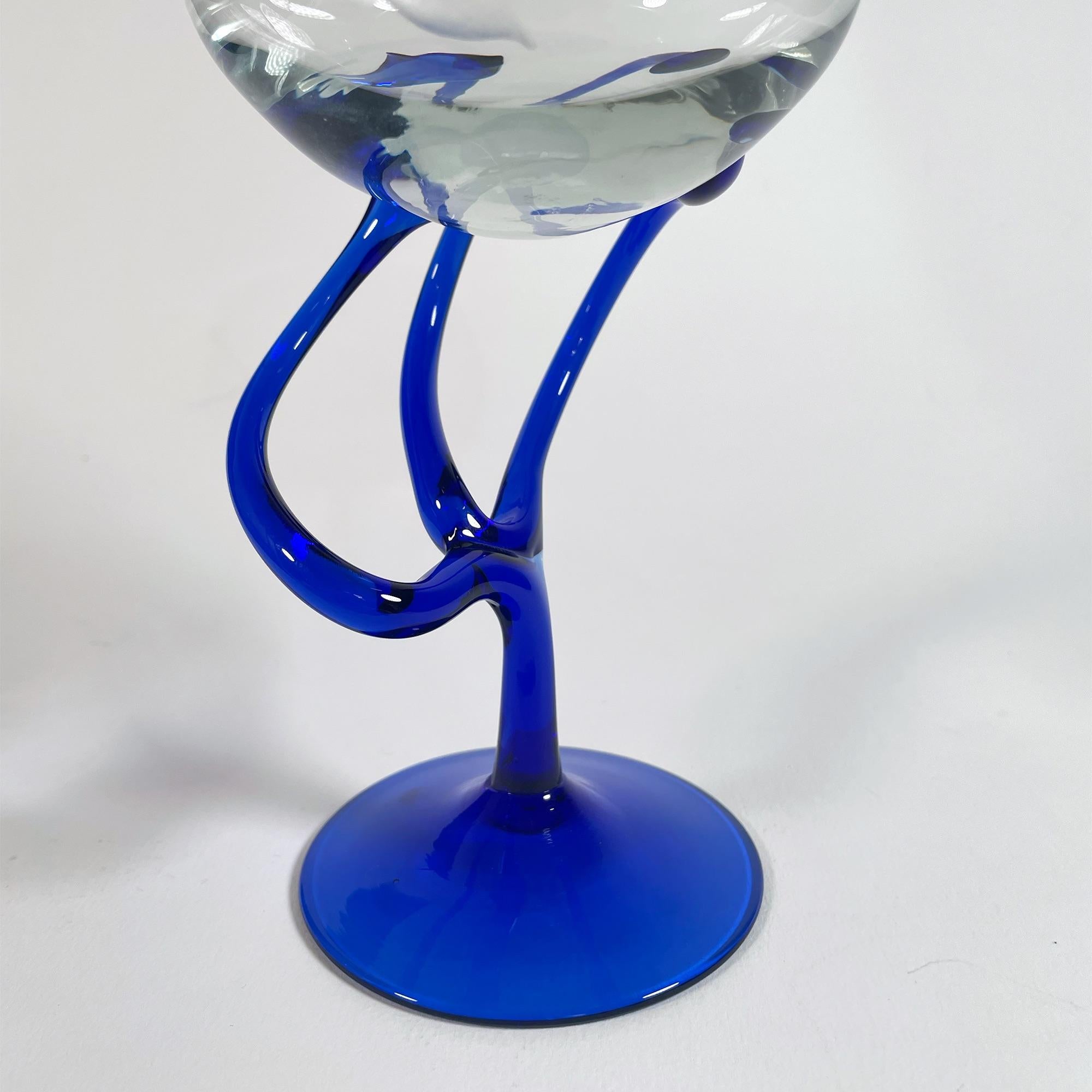 Discover the enchanting beauty of this exquisite set of five large wine glasses, expertly crafted from hand-blown Murano glass in the 1990s. Each glass features a strikingly curved design, standing at 19.5 cm tall with a diameter of 8.5 cm. The