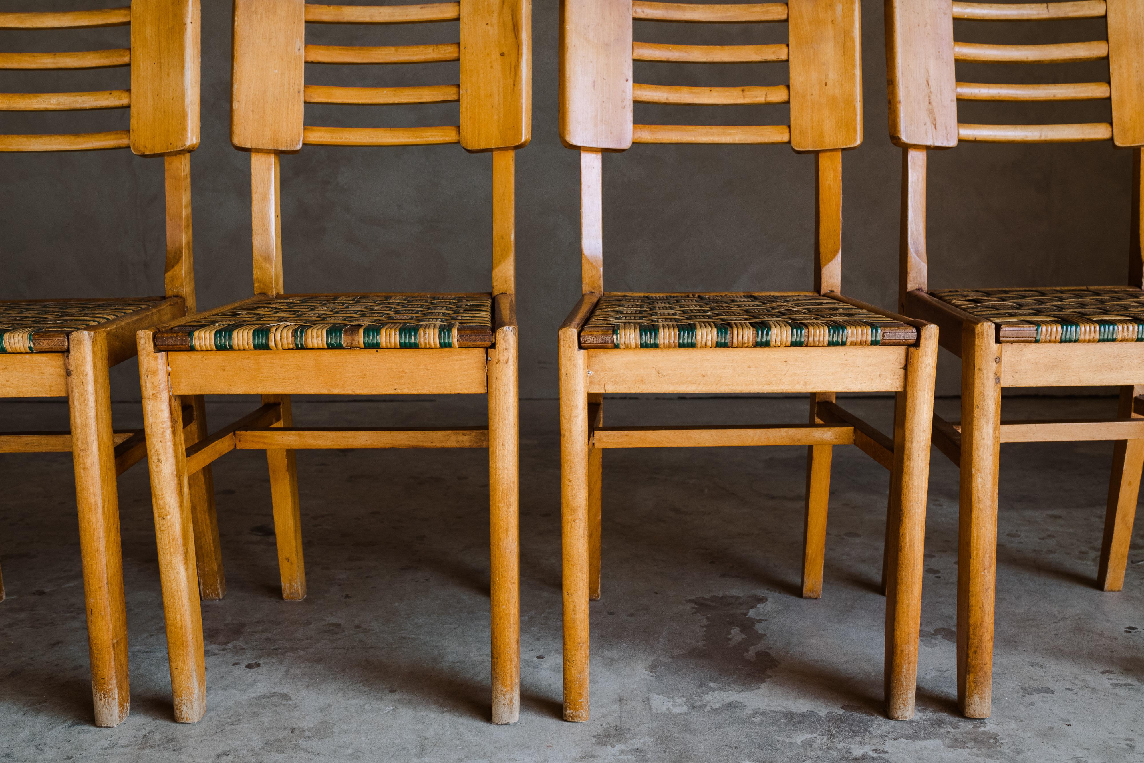 Set of five dining chairs by Pierre Cruege, France, 1940s. Solid oak construction with cane seats. Light wear and patina.