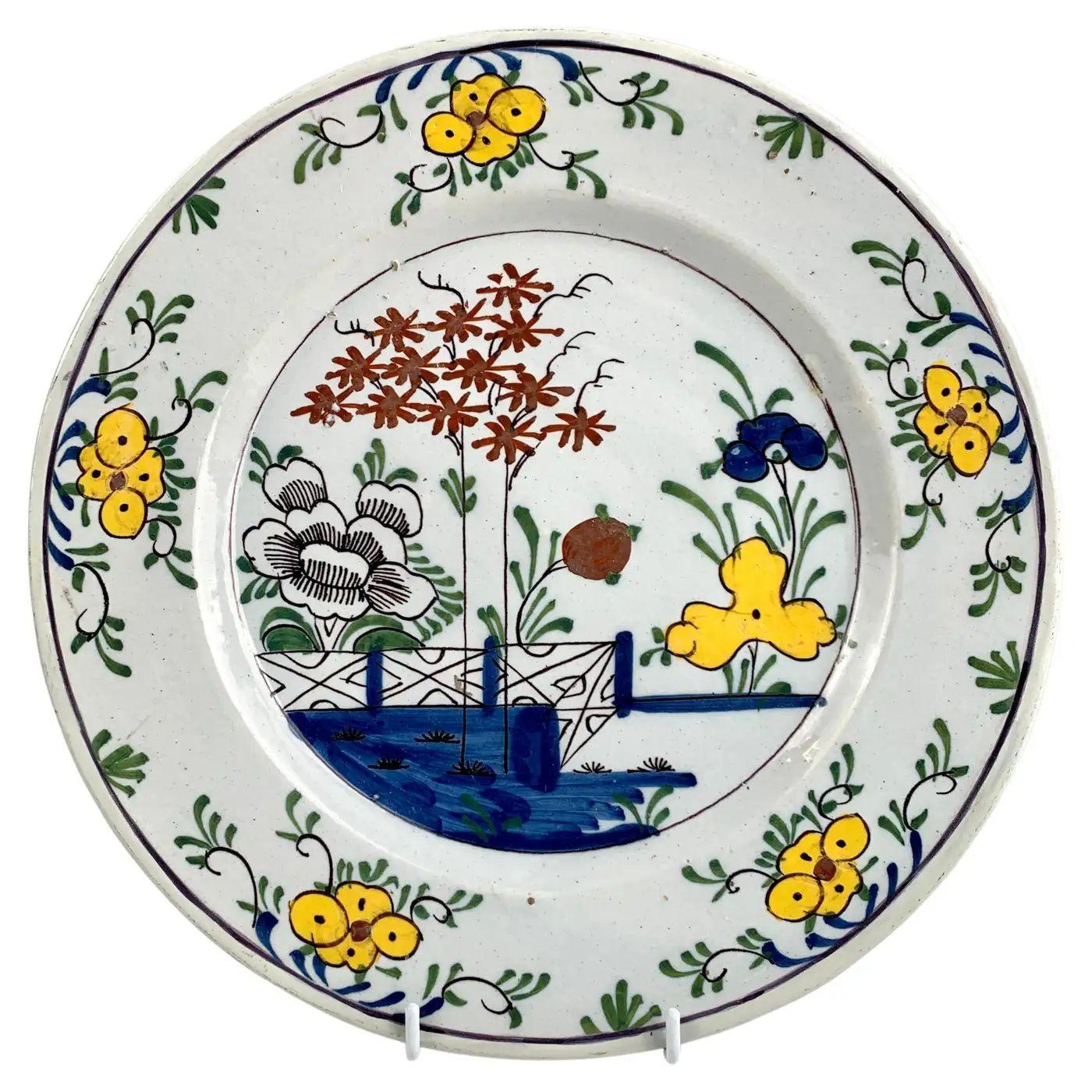 This group of five hand painted Dutch Delft polychrome plates makes a lovely set.
Each plate features a flower-filled garden scene in the center with predominant blue, green, and yellow.
Touches of orange, iron red, and manganese add to the visual