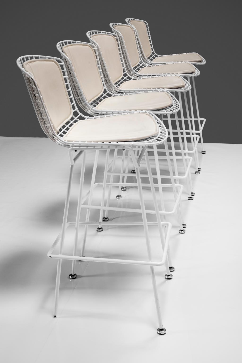 Harry Bertoia Counter Stool for Knoll White Powder Coated Steel with White Leather Cushions seats and backs. This set of five counter stools with both seat and back cushions in white leather are as elegant, strong & functional as when they were