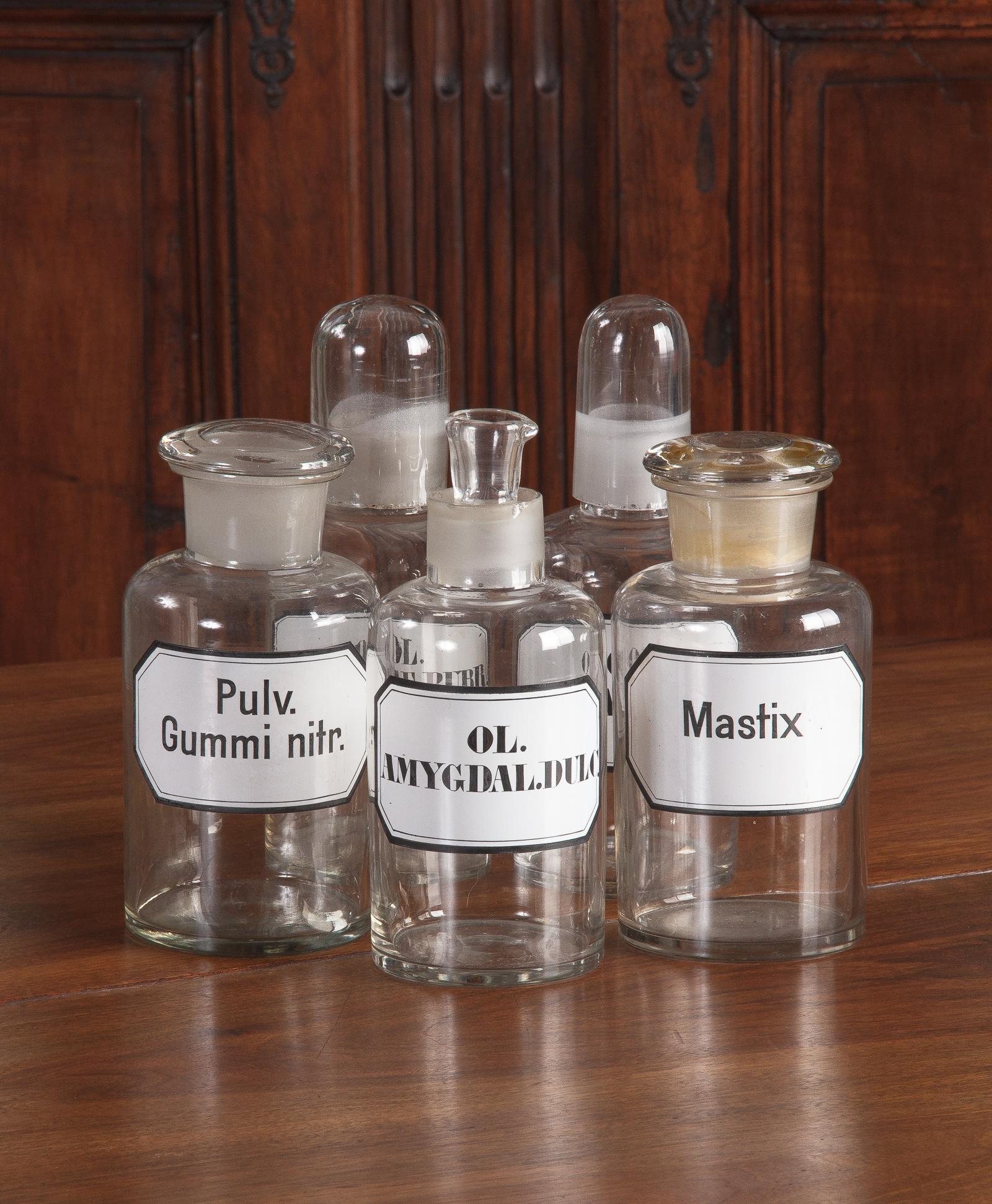 A set of 5 glass pharmacy bottles from the Alsace Region of France. Each bottle has a removable lid and its original label.
Bottles with rounded tops are 10