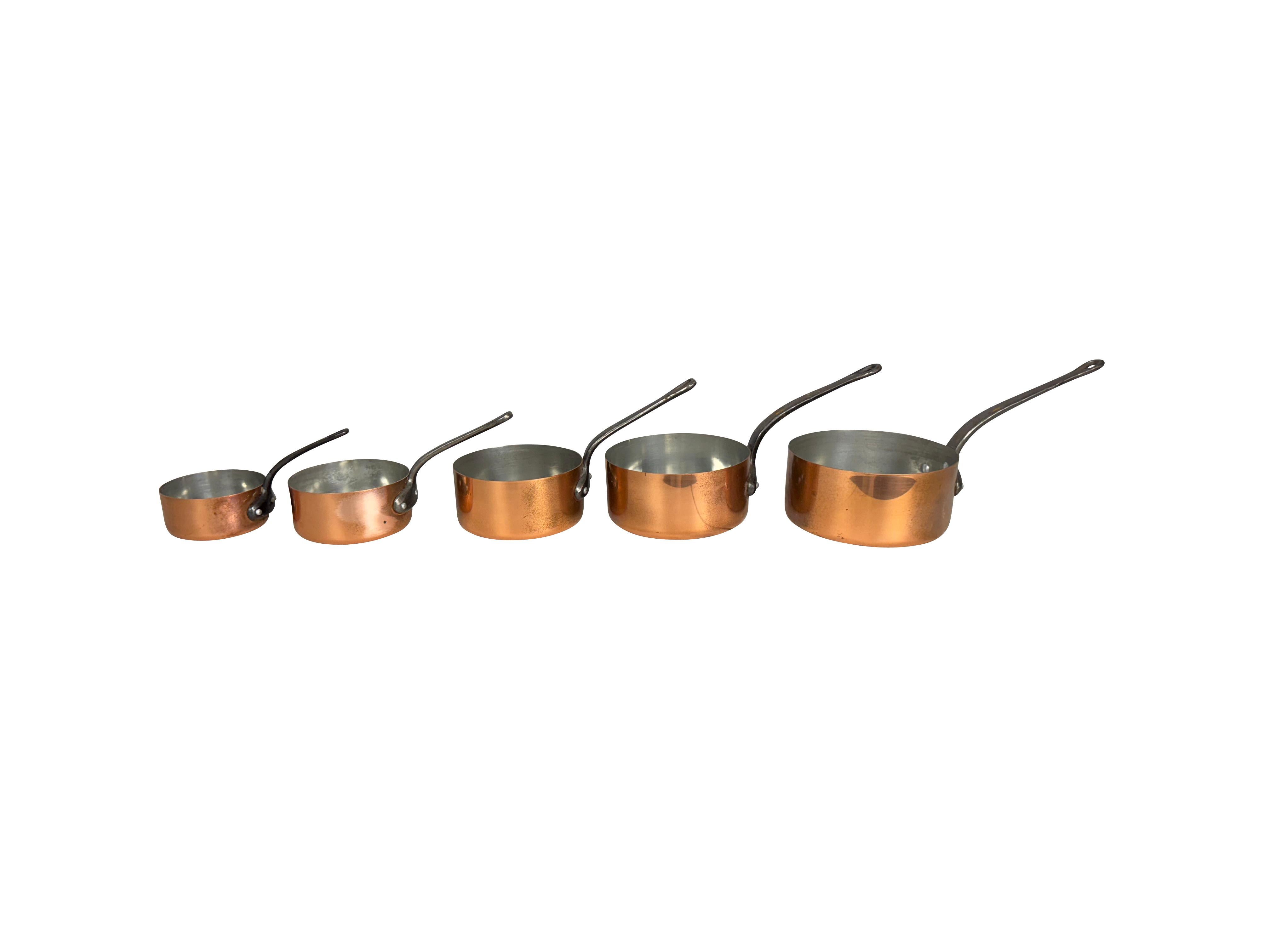 A set of 5 graduated copper saucepans with iron handles. A beautiful set of 5 vintage copper saucepans, a must for your French-inspired kitchen. Made in the first half of the 20th century, this set of 5 saucepans is in excellent vintage condition