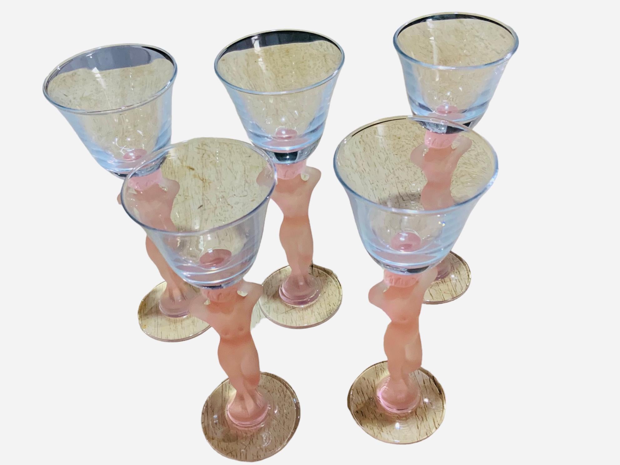 This is a set of five frosted nude figure stem glasses. It depicts a pink frosted nude Caryatids stem liquor glass.
