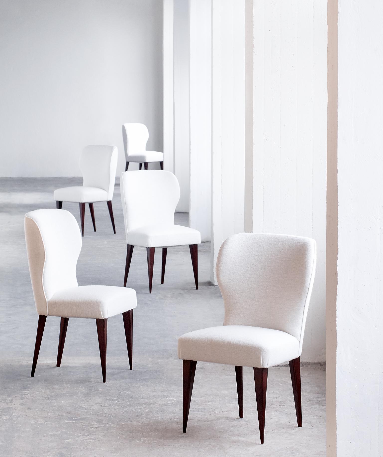 A rare set of five dining chairs designed by Gio Ponti in collaboration with Lio Carminati for the Casa E Giardino company in 1942. The particularly graphical lines of the tapered mahogany legs and the curved backrests give the chairs a modern and
