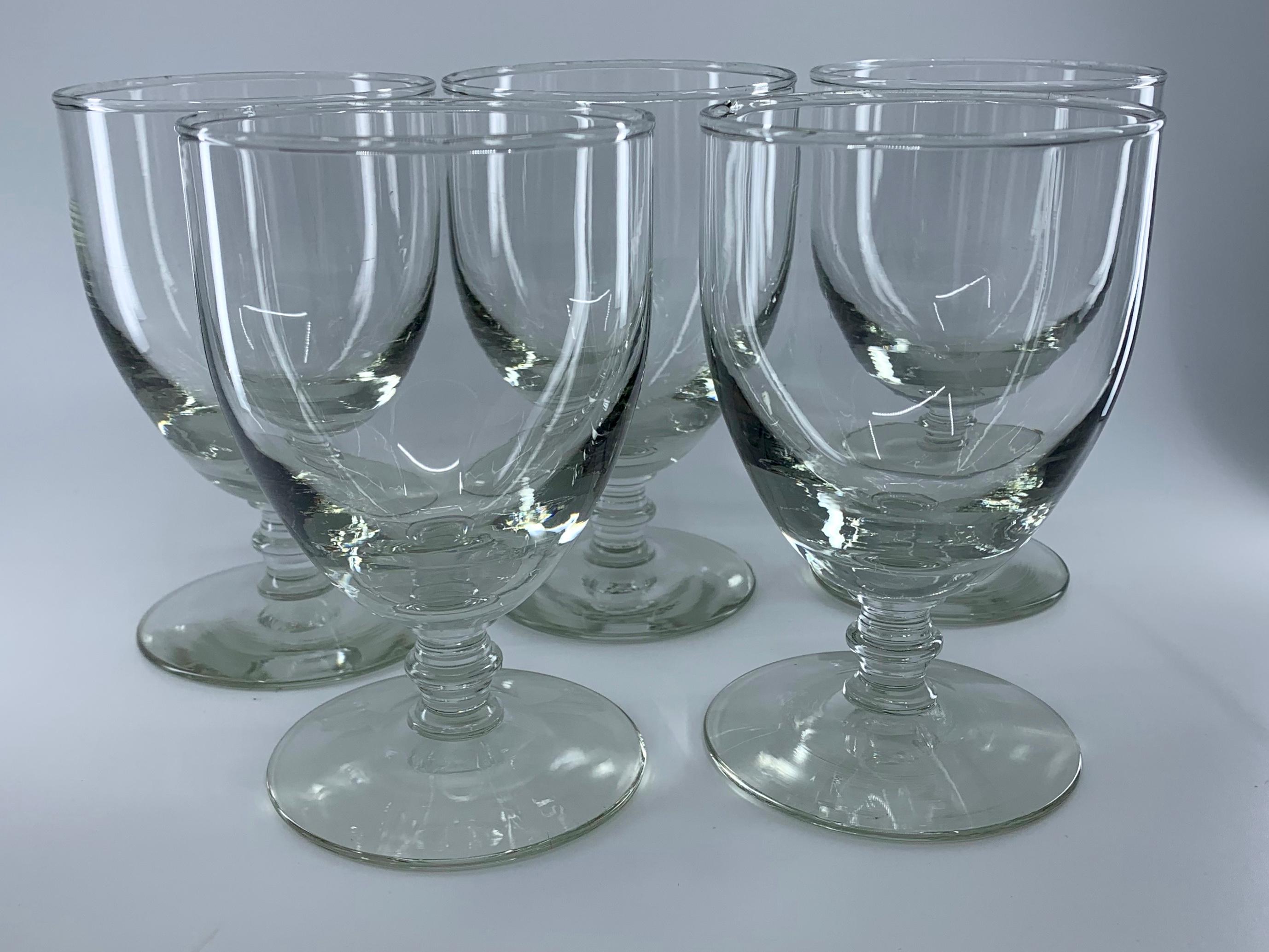 Set of five glass goblets. Baluster-footed hand blown water glasses, England, early 20th century.
Dimensions: 3.38