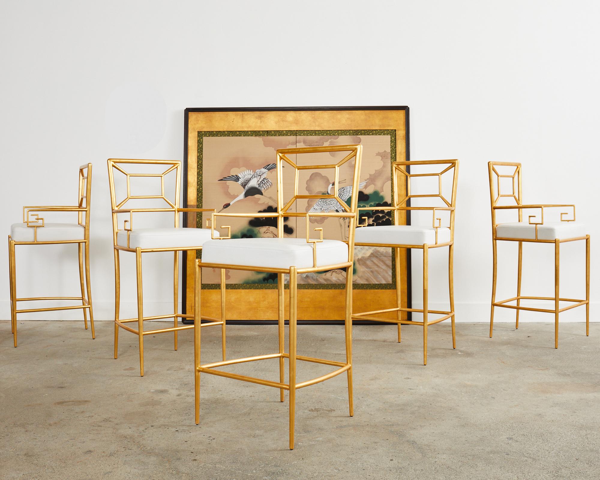 Glamorous set of five barstools by iconic furniture maker Century Furniture. The stools feature a metal frame covered with squares of gold leaf. The bar height frame has a square back and generous seat upholstered with a faux leather ostrich design