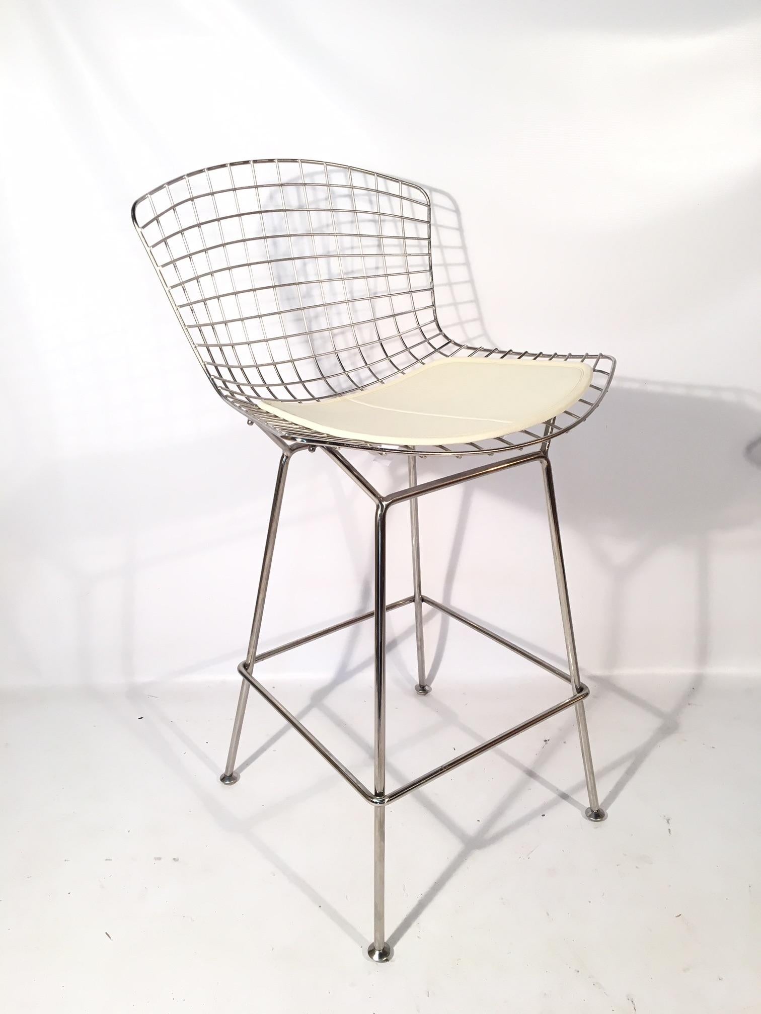 Set of five iconic chrome wire bar stools designed by Harry Bertoia for Knoll. This set is unmarked by Knoll, signifying a pre-2004 production. Frames in excellent condition with pads in very good condition showing very minor age appropriate wear.