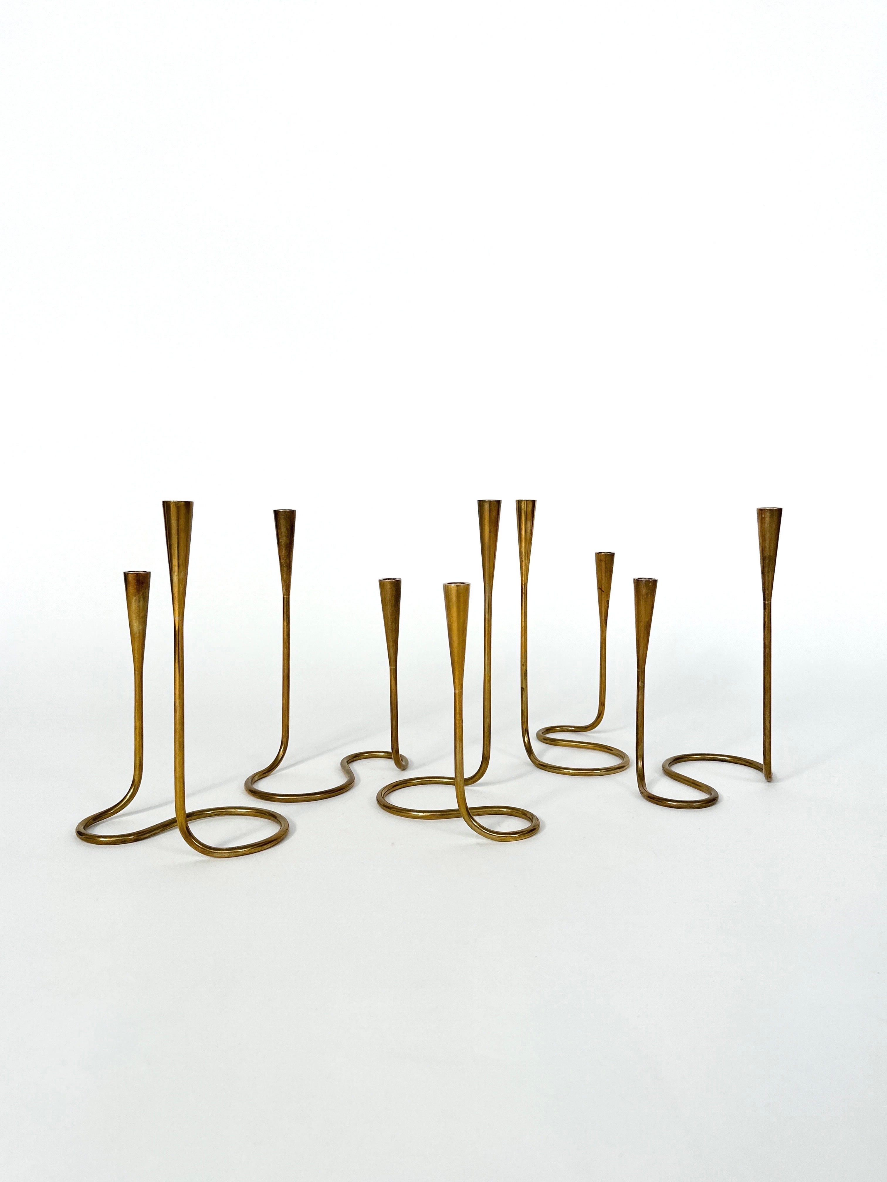 Set of five Illums Bolighus serpentine double candelabras in solid brass, made in Denmark in the 1950s.

They have a beautiful patina, with sign of use and age.

For thin candles with a diameter of 12 mm
Height: 20 cm-25 cm

