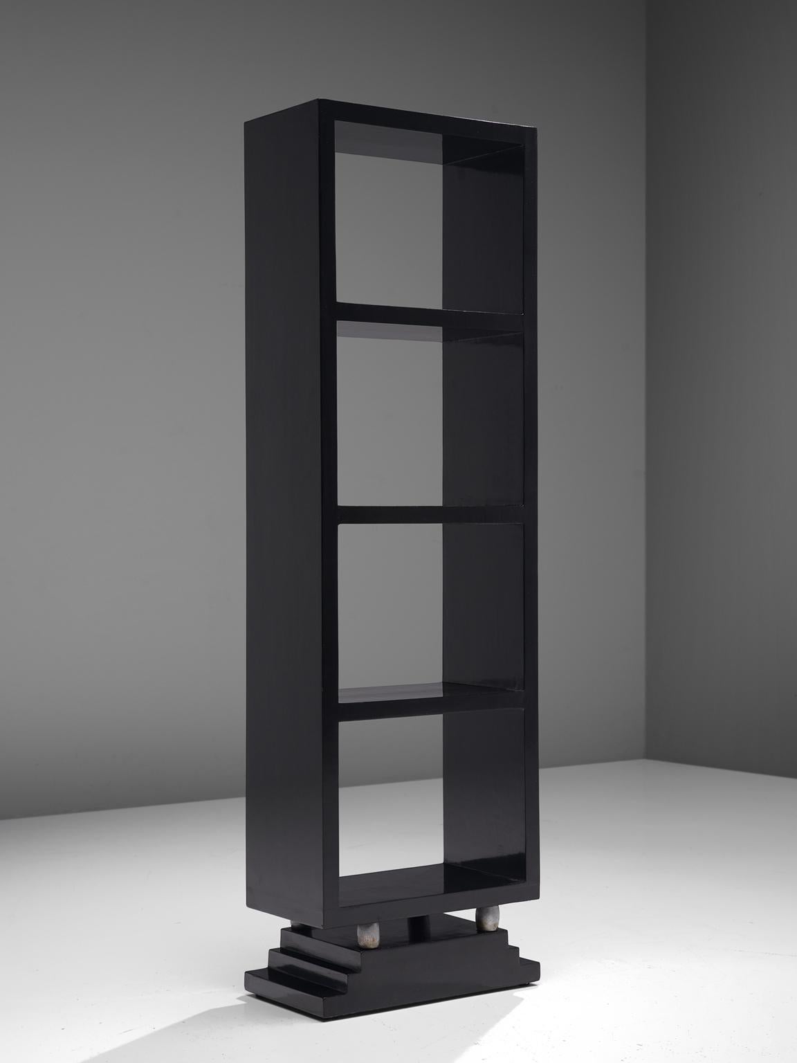 Bookcases in the style of Osvaldo Borsani, black veneered wood and metal, Italy, 1950s.

Elegant black lacquered bookcase. With its thick, high gloss lacquered lines the pieces have a graphical expression. The storage unit rests on metal legs,