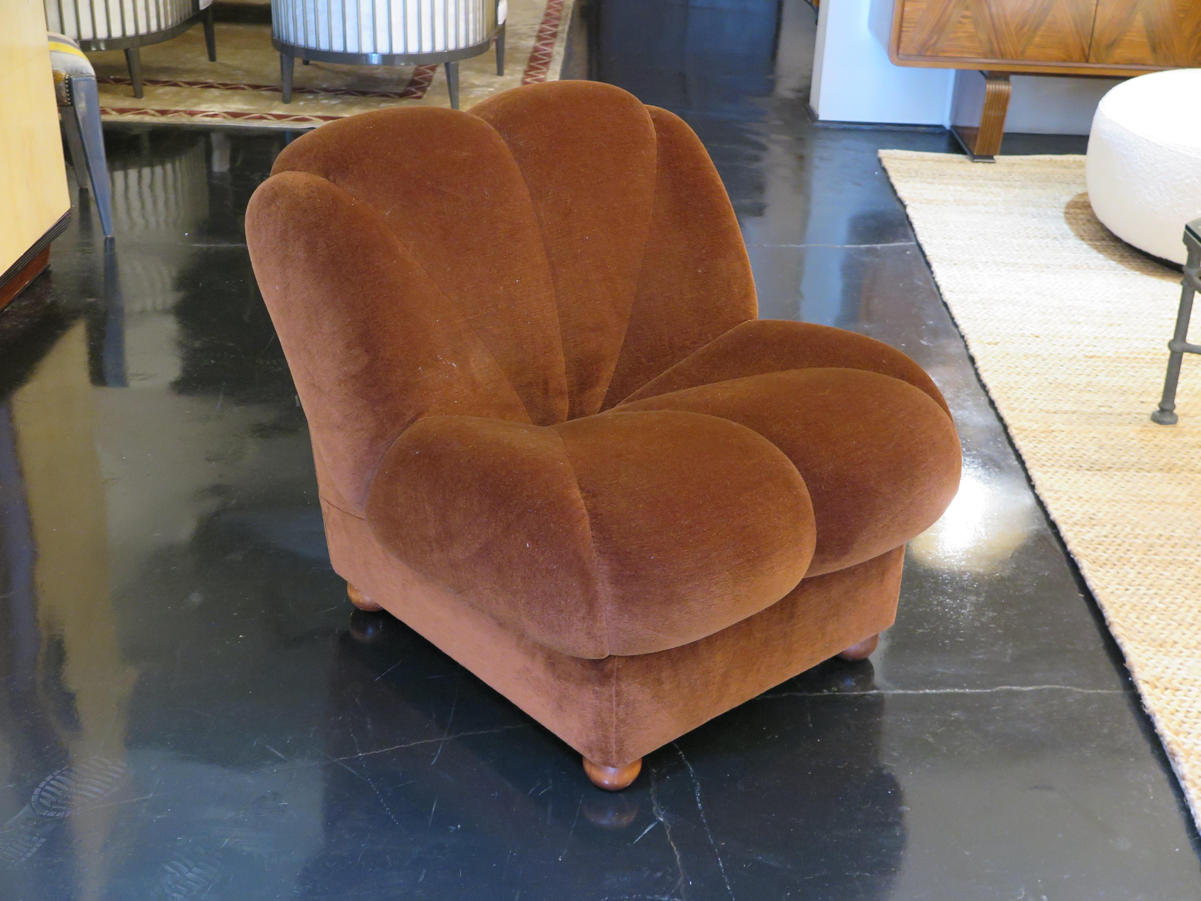 Single mid-century slipper chair with scallop edges forming a clamshell design. The chair is shown in its original brown velvet upholstery (still good condition) and houses four wooden ball feet.  This is sold as a single lounge chair.  