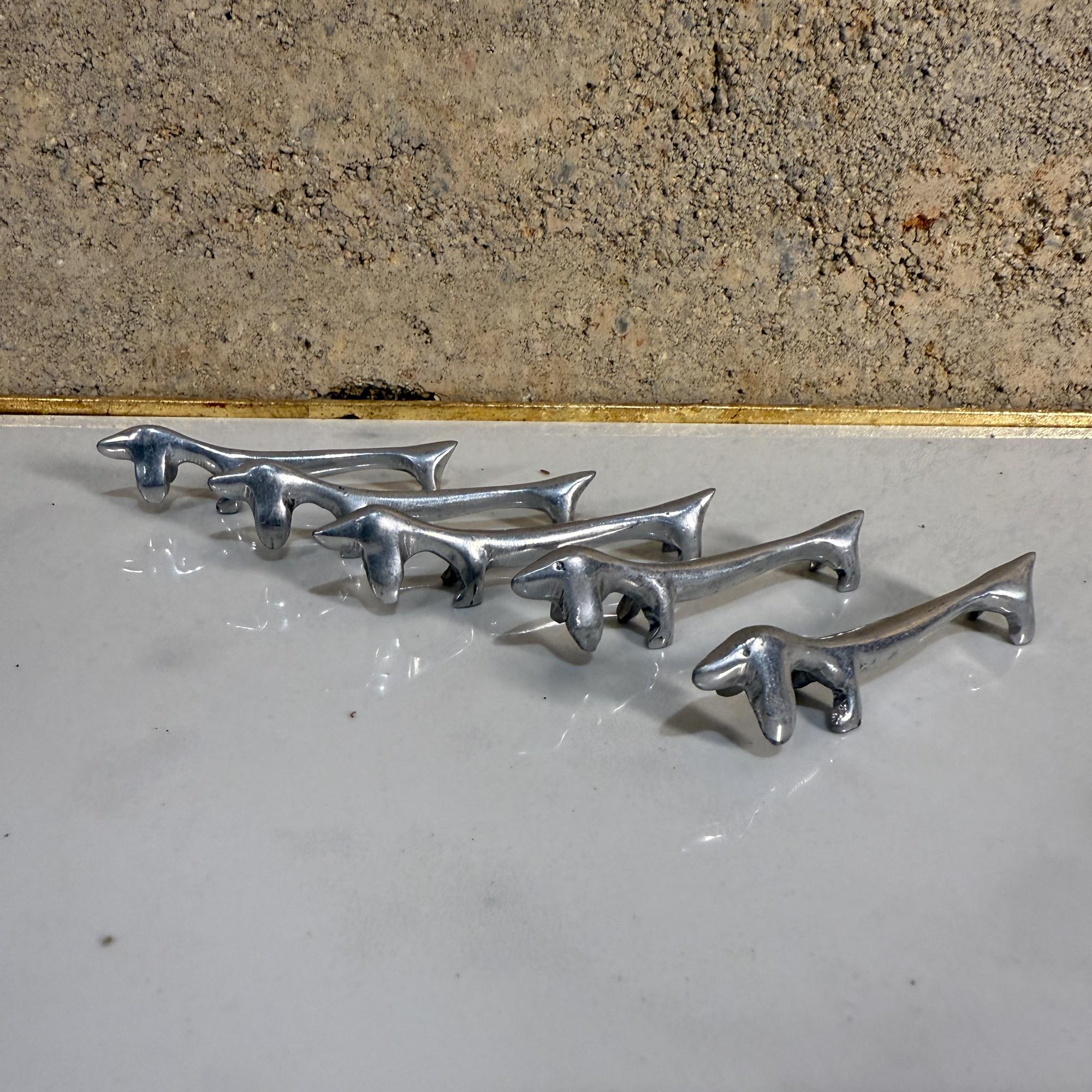 Pour votre considération, un ensemble de cinq (5) italien vintage argenté (ou aluminium) teckel chien repose-couteau. Non marqué. 

Dimensions : .75