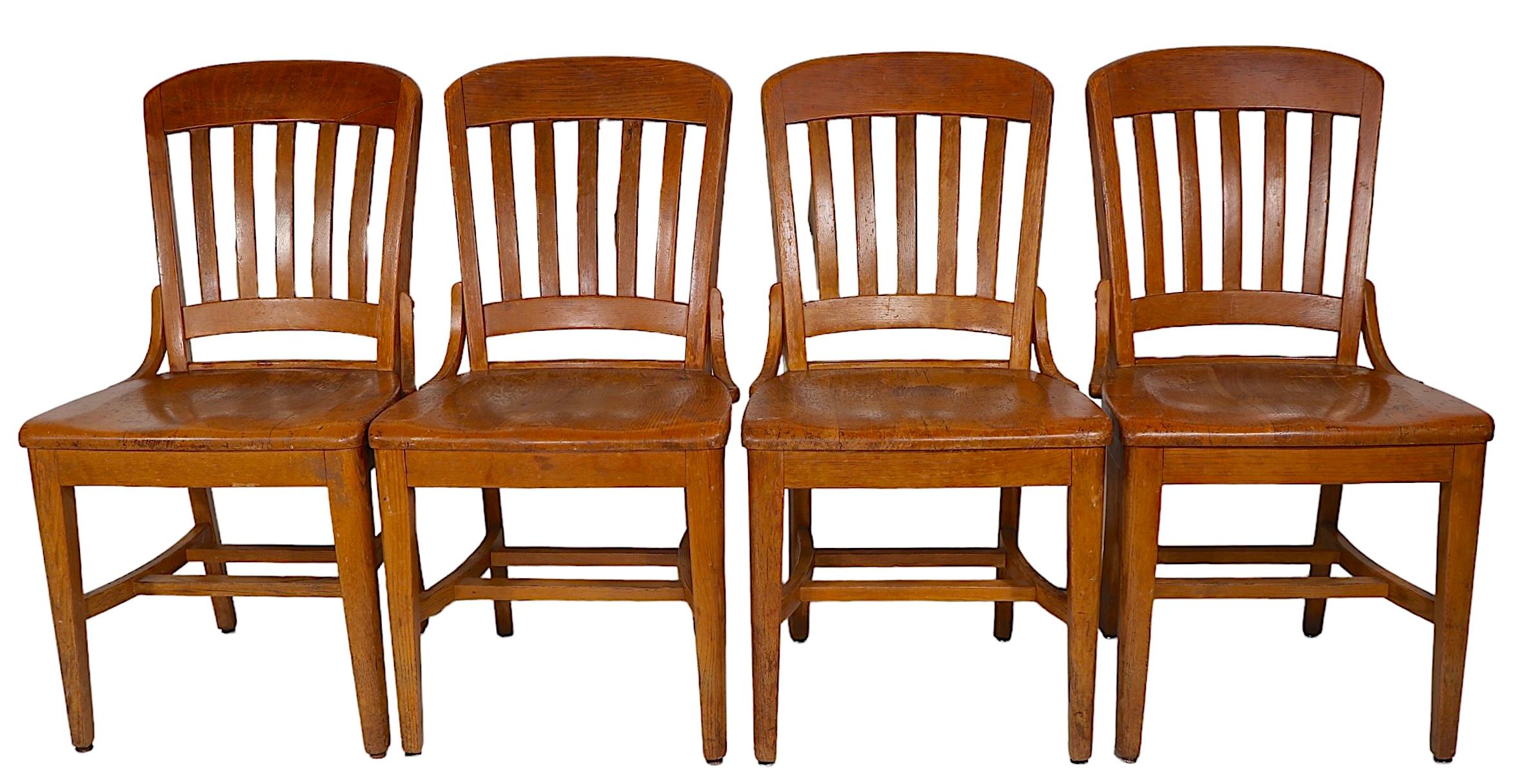Nice set of five oak office, or desk chairs, constricted of solid oak, all are in structurally sound, sturdy, and  ready to use condition. 
 This lot consists of four side chairs, and one arm chair, executed in the manner of Gunlocke, or The  Marble