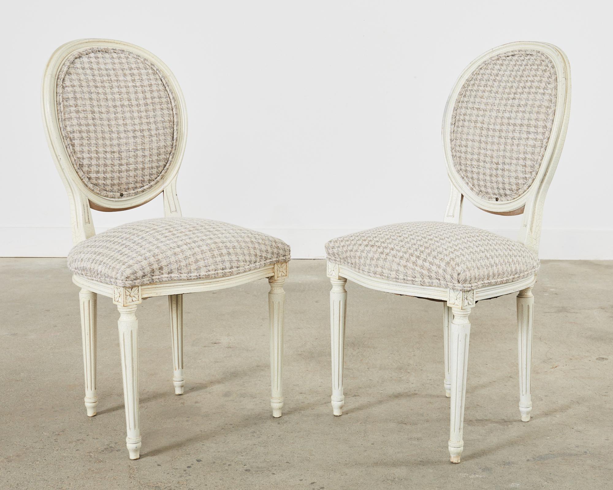 20ième siècle Ensemble de cinq chaises de salle à manger peintes de style Louis XVI avec pied-de-poule en vente