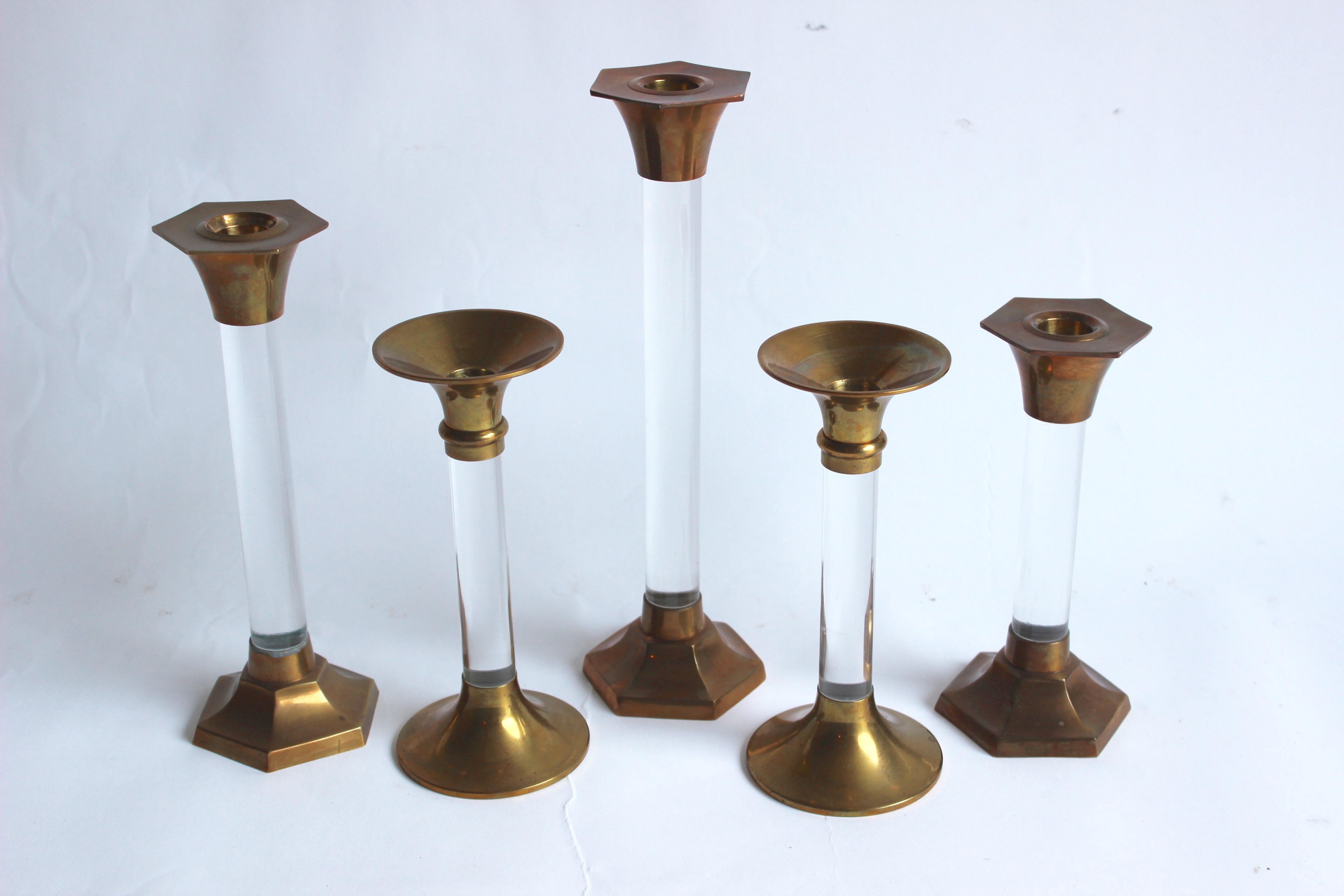 Set of five brass and Lucite candlesticks.

Pair of round candlesticks 8