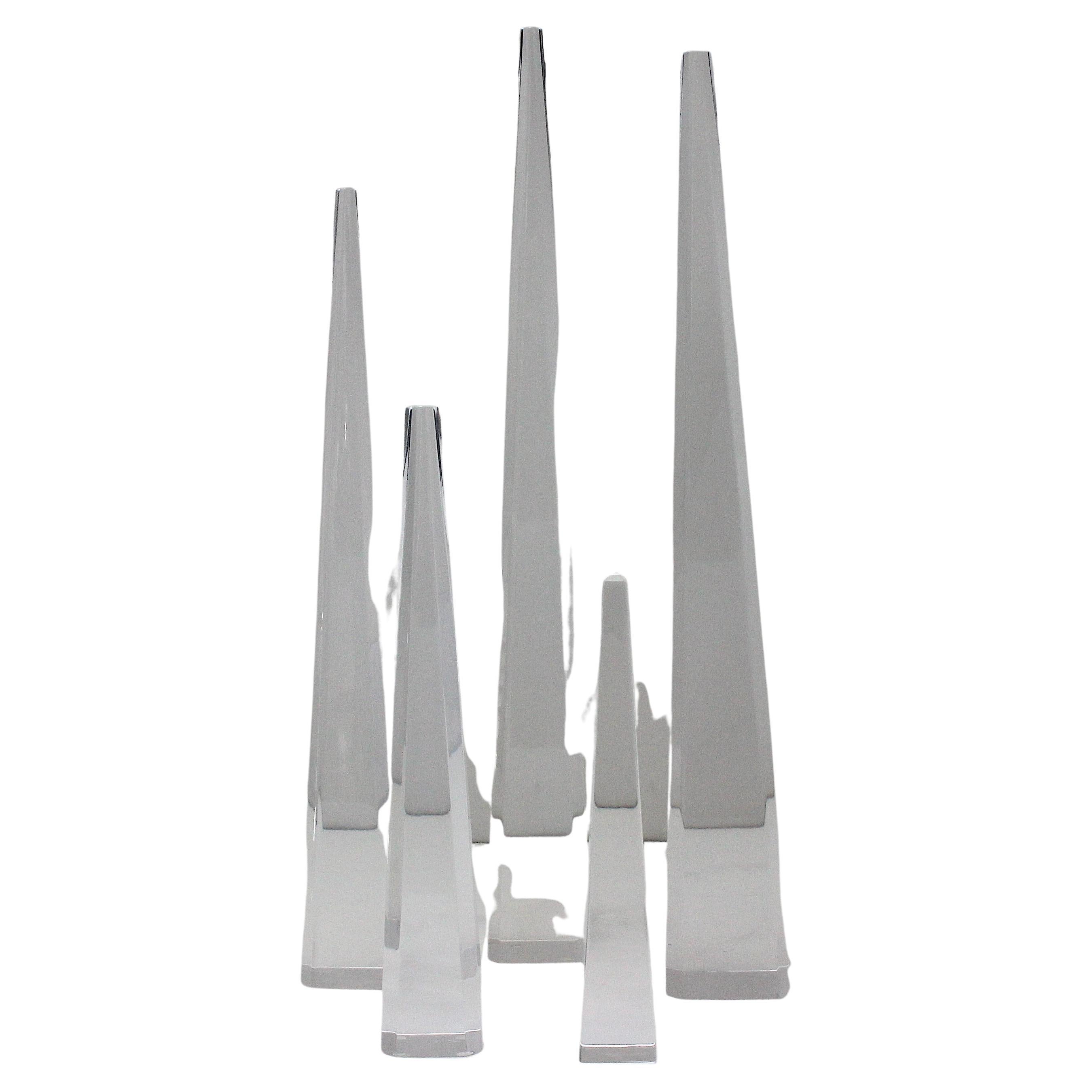 This stylish and chic five piece set of lucite obelisks date to the late 1970s to the 1980s. 

Note: We have had these pieces professionally polished. 

Note: Tallest is 19.25