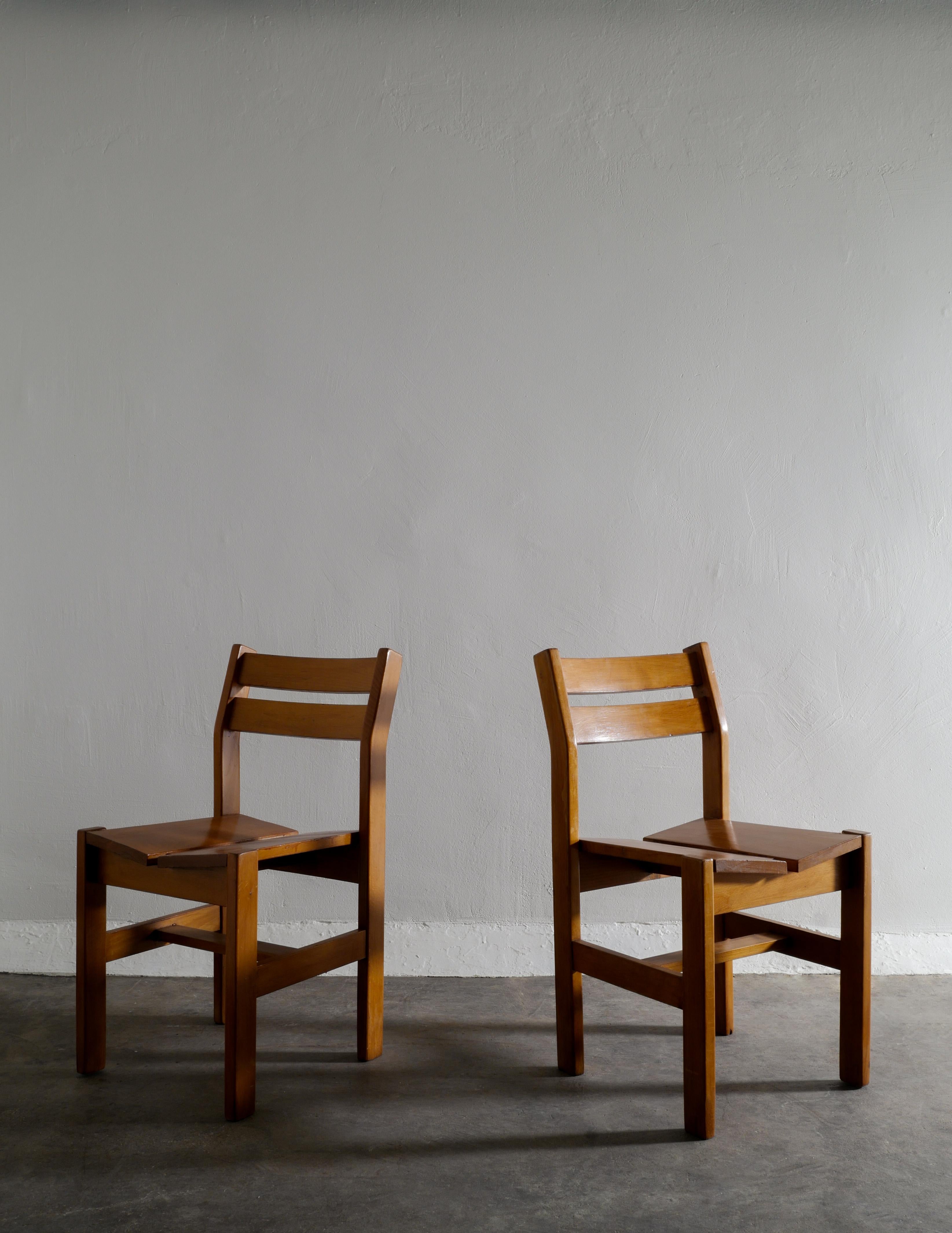 Rare set of five dining chairs in solid elm by Charlotte Perriand produced for her Les Arcs project in France during the late 1960s. In good vintage and original condition with patina from age and use. These chairs also flirt a little bit with