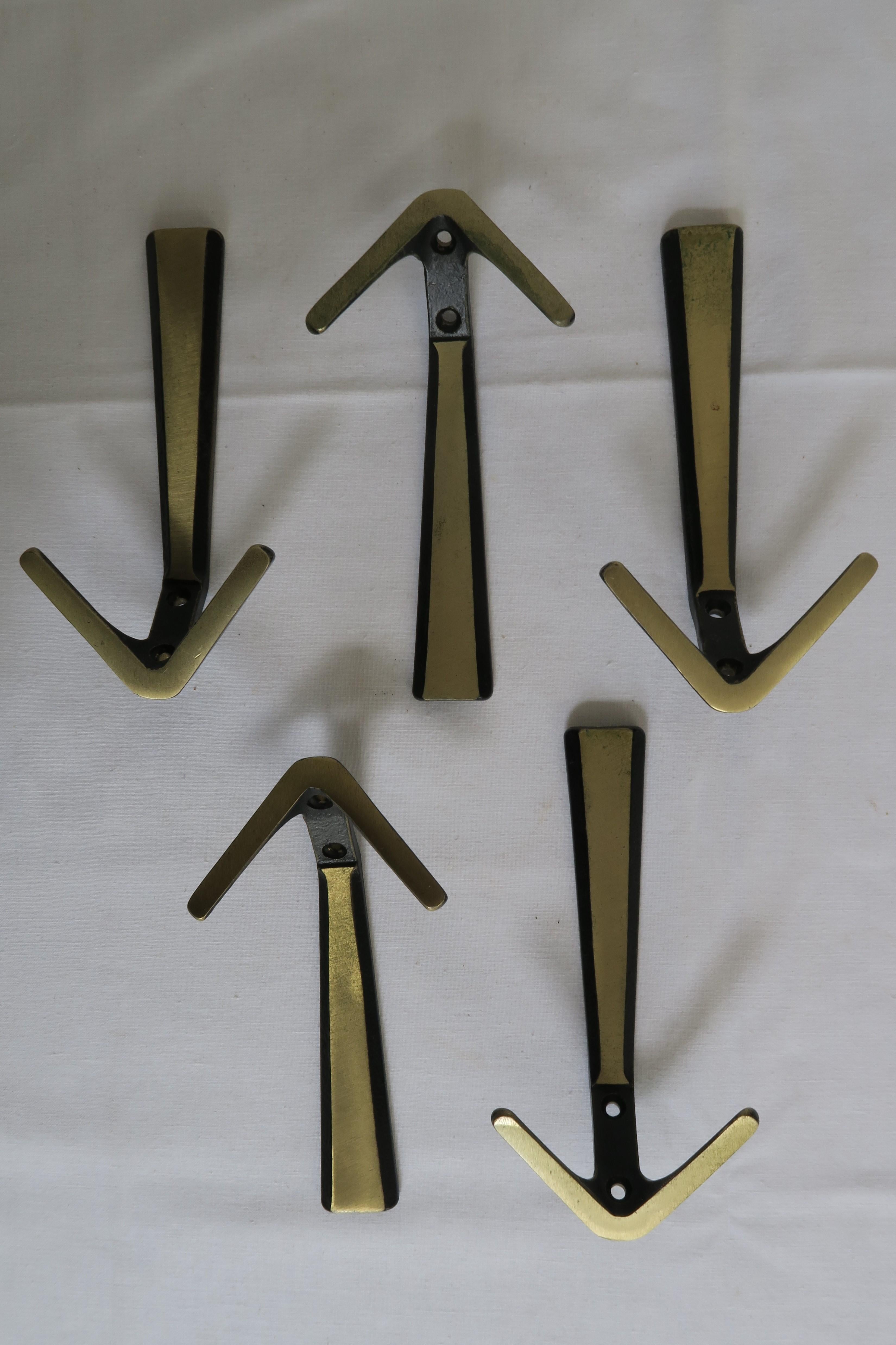 For sale are five beautiful Mid-Century Modern coat hooks. They have been made in the style of the renowned Austrian Werkstätte Hagenauer. The hooks were made From Vienna bronze and have a warm age appropriate patina.

The objects are in excellent