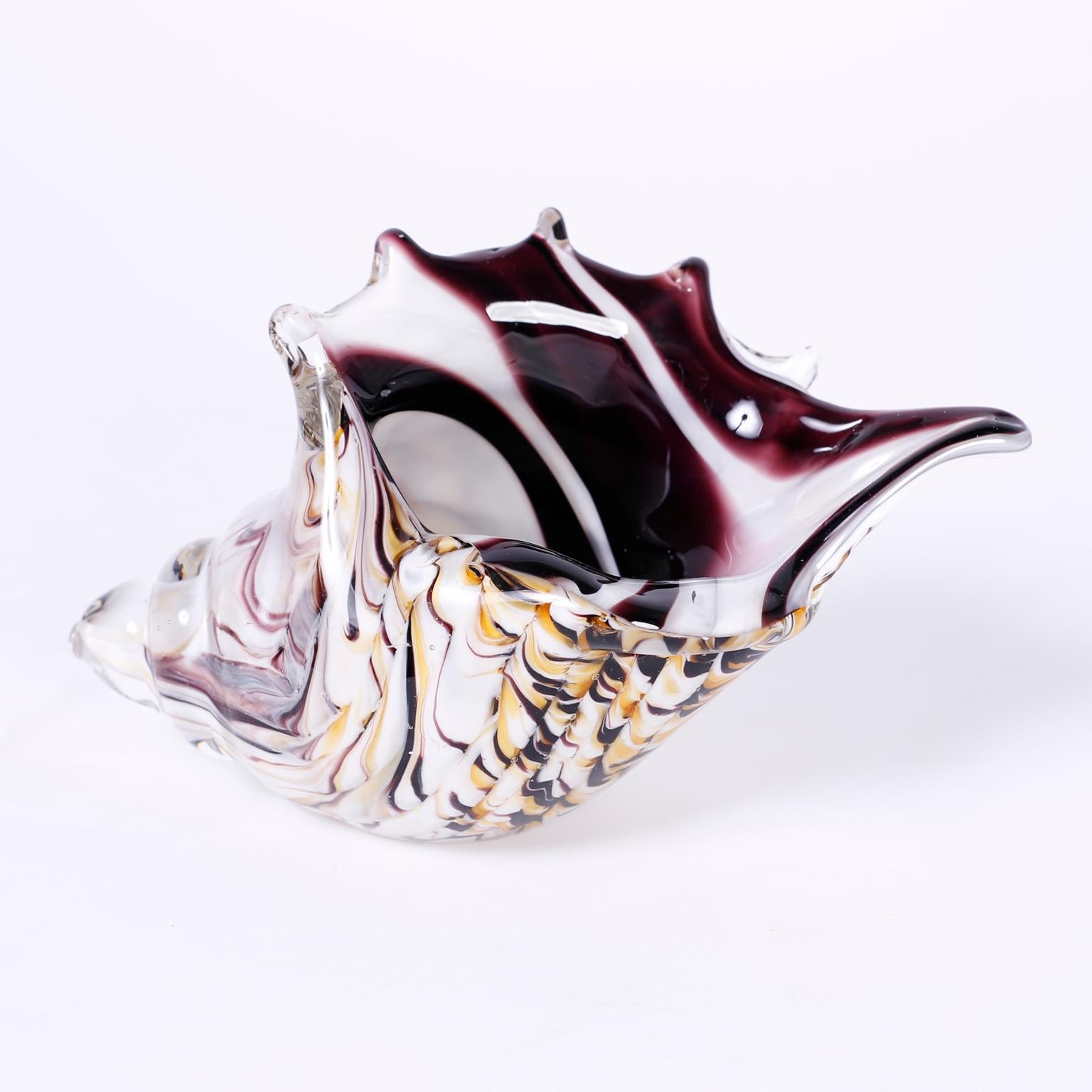 Five hand blown Murano glass conch shells in assorted colors and patterns all executed with amazing expert technique. 
Measures:
H: 5 W: 9 D: 4
H: 4 W: 7 D: 4
H: 4 W: 8 D: 4
H: 5.5 W: 9 D: 3
H: 5 W: 10 D: 4.