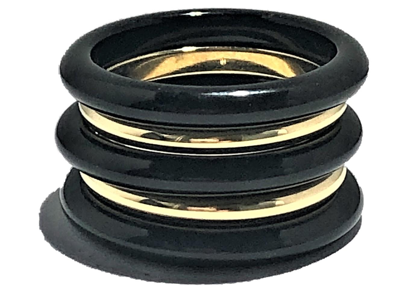 This tailored versatile set of stacking bands is comprised of three 3mm wide onyx bands alternating with two 2mm wide 18K Yellow Gold bands. The set looks and feels great. The five bands measure 1/2 inch wide when worn together. The gold bands are
