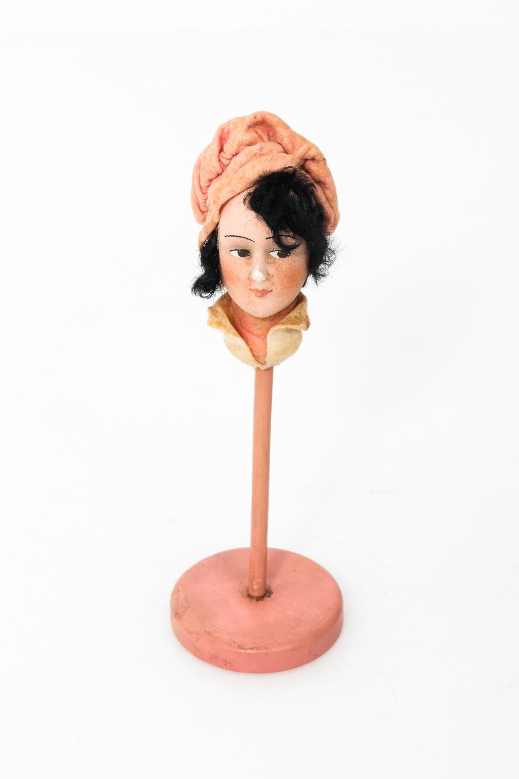 Set of five papier Mache hat stands use in a millinery shop for the display of hats, circa 1920s. Each stand depicts a unique figure in flapper style dress and sizes vary from 9.00 Inches to 13.00 Inches height. Please note of wear consistent with