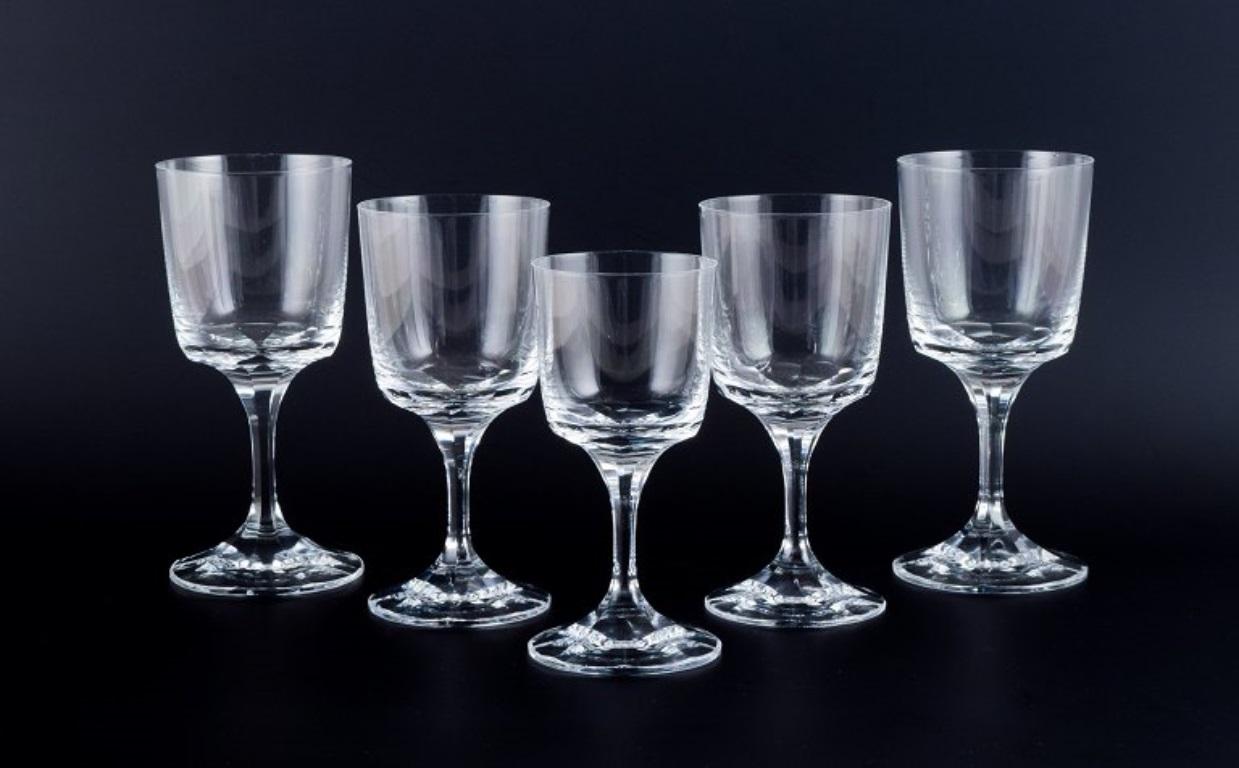 A set of five René Lalique Chenonceaux glasses.
Four red wine glasses and one white wine glass.
Clear mouth-blown crystal glass with faceted stem.
Mid 20th century.
Signed Lalique, France.
In good condition, with minimal chips at the top on all five
