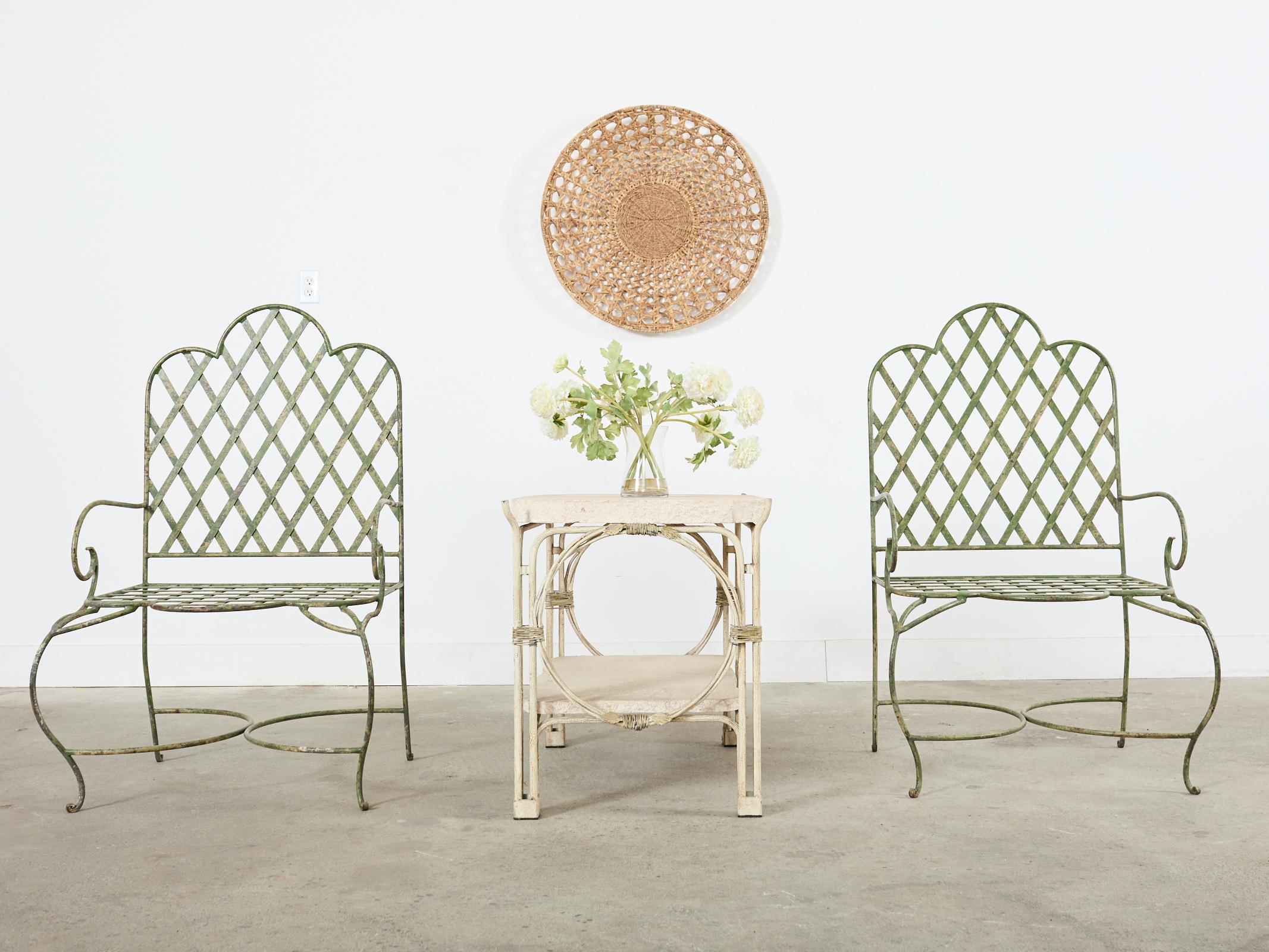 Whimsical set of five iron patio and garden armchairs made in the style and manner of Rose Tarlow. The chairs feature large hand-crafted iron frames with a neoclassical style lattice inset on the seat and backs. The frames have a gracefully curved