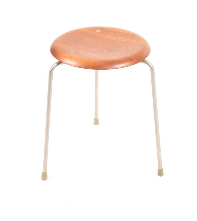 Set of five round stools with teak seats, the set is the first version on this Classic with brass details in the seat. Designed in 1954 by Arne Jacobsen and Søren Hansen for Fritz Hansen, Denmark. Nice original condition.