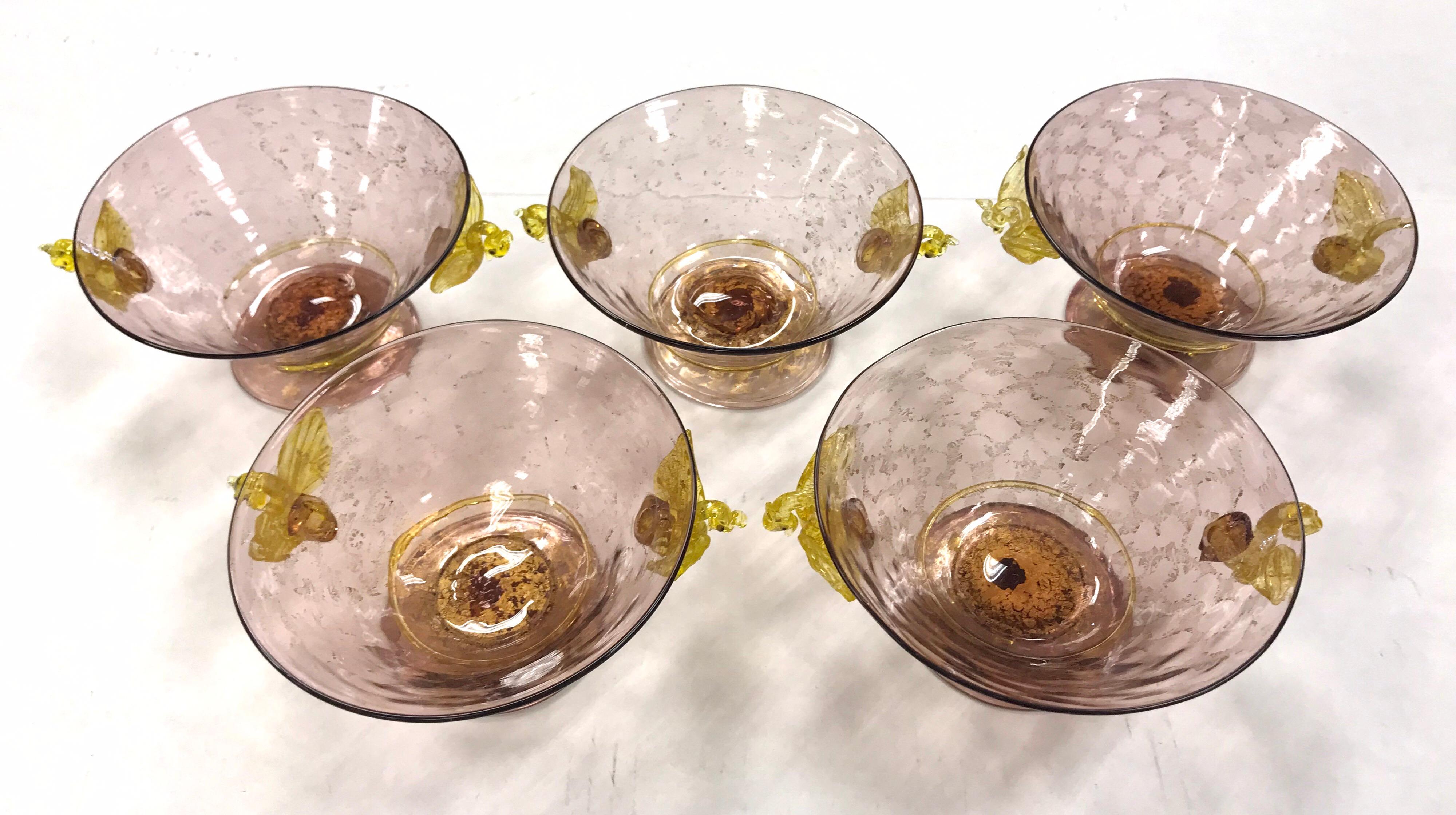 This is a set of rare, hand blown Venetian bowls made by Salviati, circa 1920s. They feature a figural golden yellow swan connector and applied applique. The color is pink with gold leaf inclusions which works nicely with a pastel palette.
