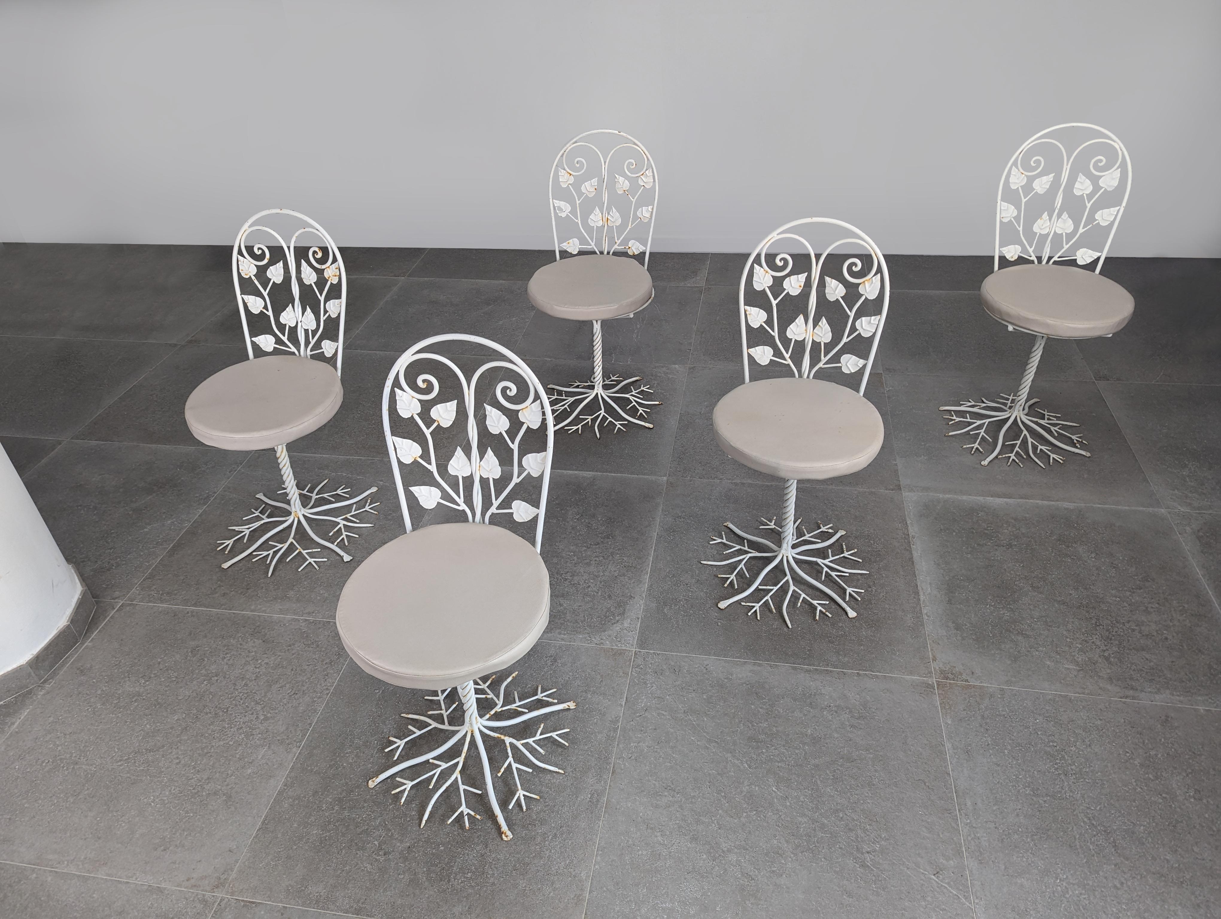 Spectacular wrought iron garden chairs, authentic sculptural works of art from the 1950s. Their unique design represents the beauty and craftsmanship of the era, with an intricate spiral trunk rising from the root-shaped base to the seat and